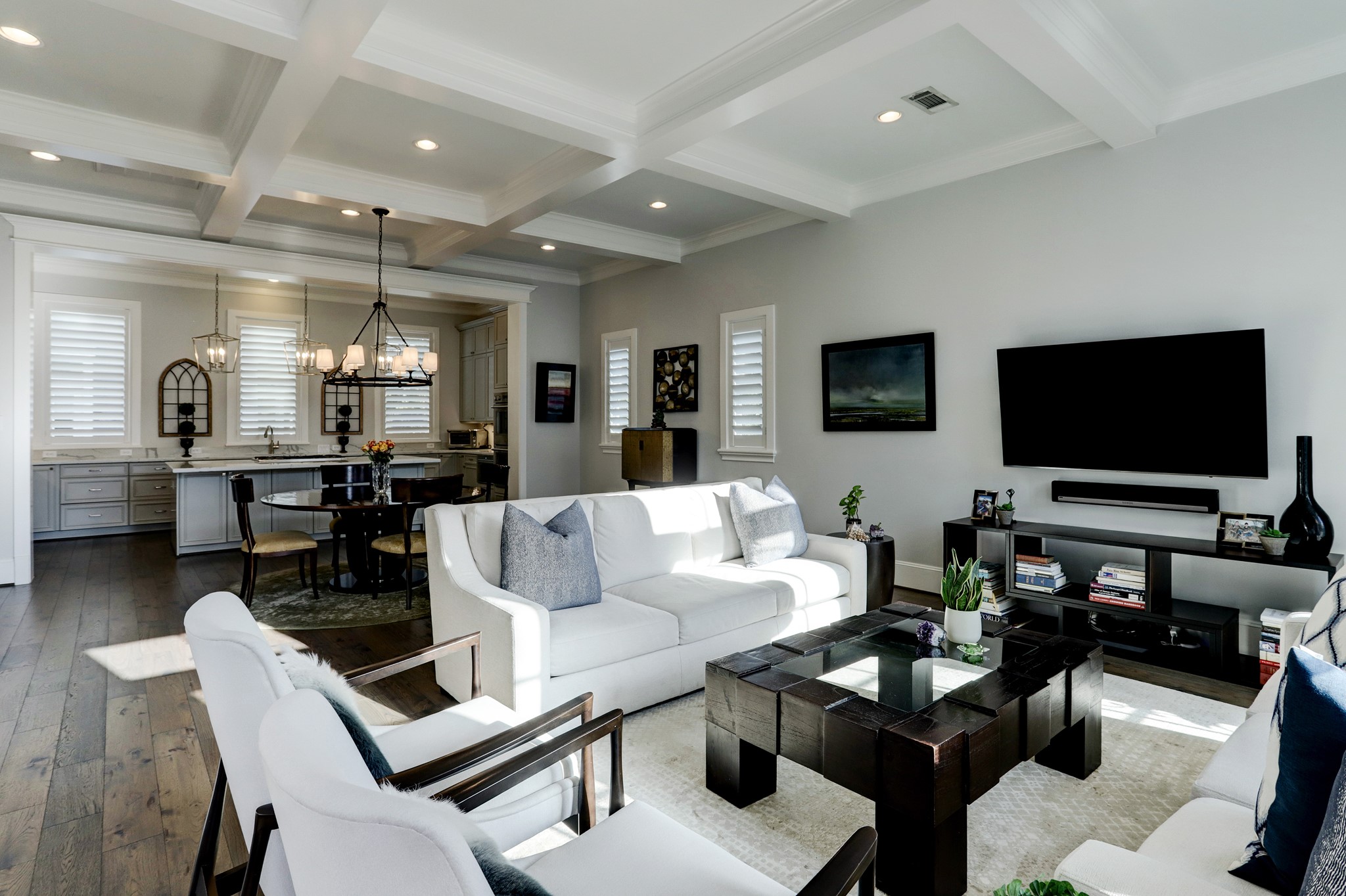 A view from the family room looking onto the open concept dining space and kitchen. It's hard to miss the beautiful ceiling details and extensive millwork around every door, window and entryway!