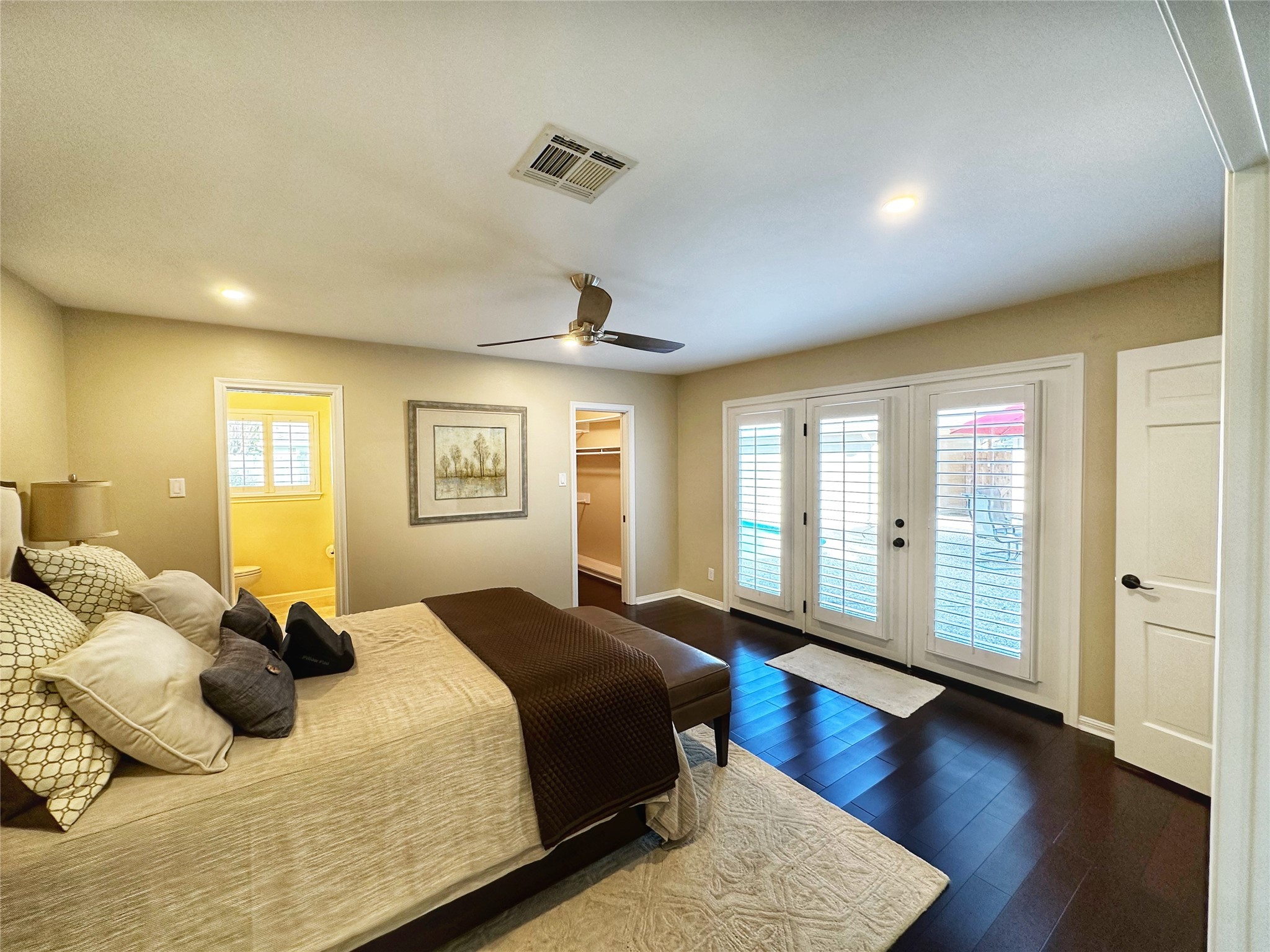 Primary with large walk in closet and french doors to the pool