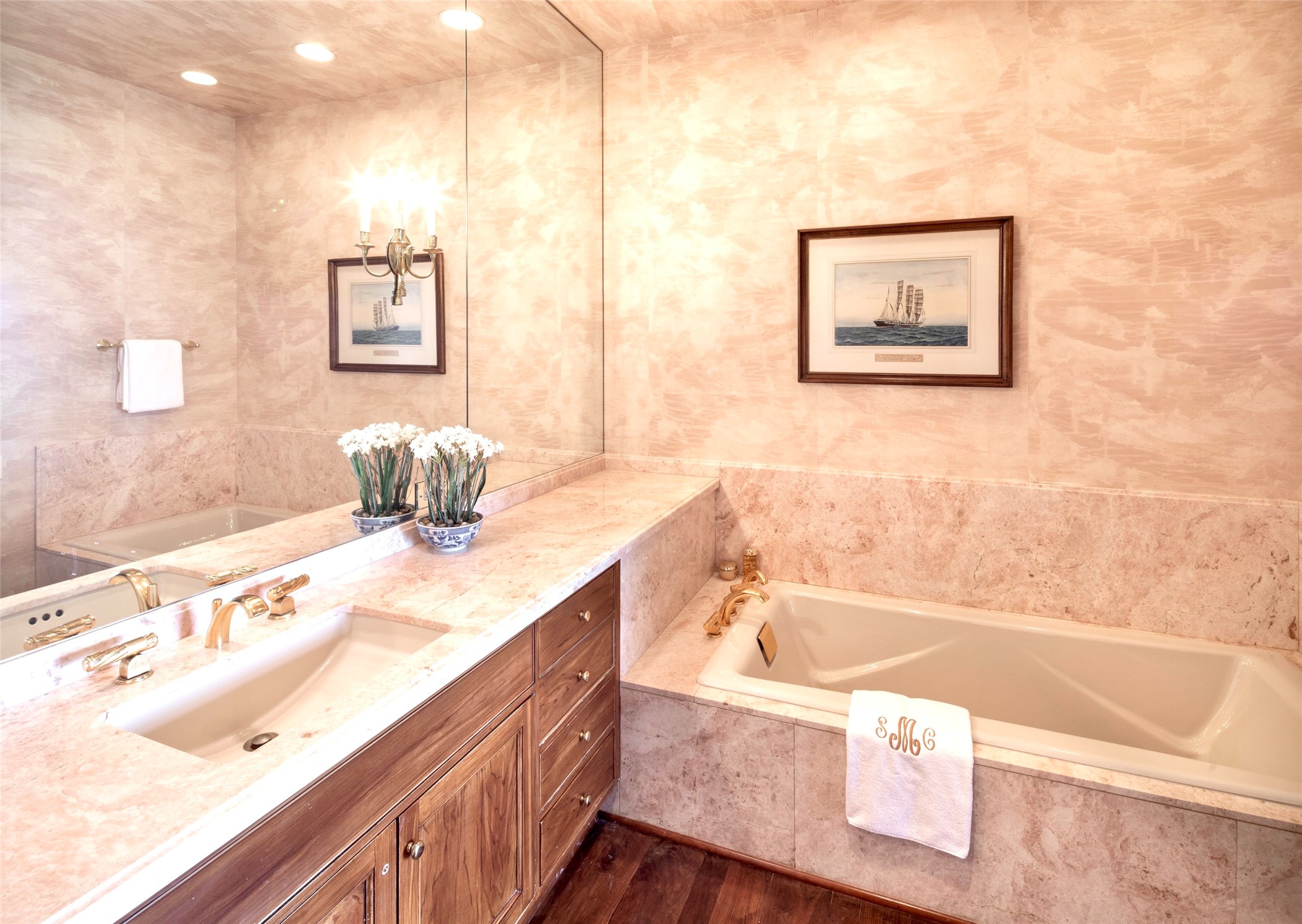 The secondary en-suite bathroom, custom slab countertops, counter to ceiling mirrors and spa tub for relaxation. 