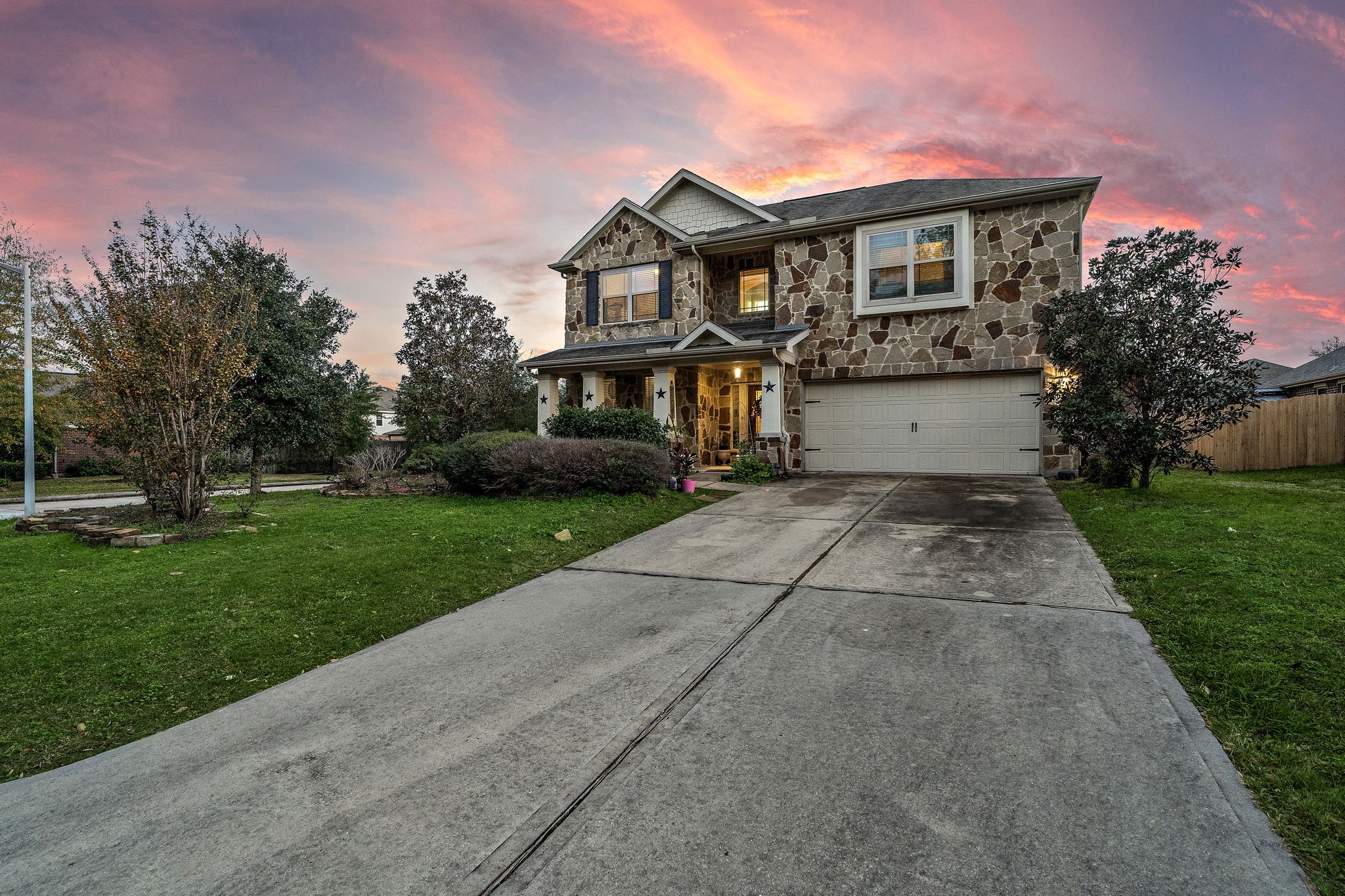 Spacious two-story home with stone accents, offering sunset views in a serene neighborhood.