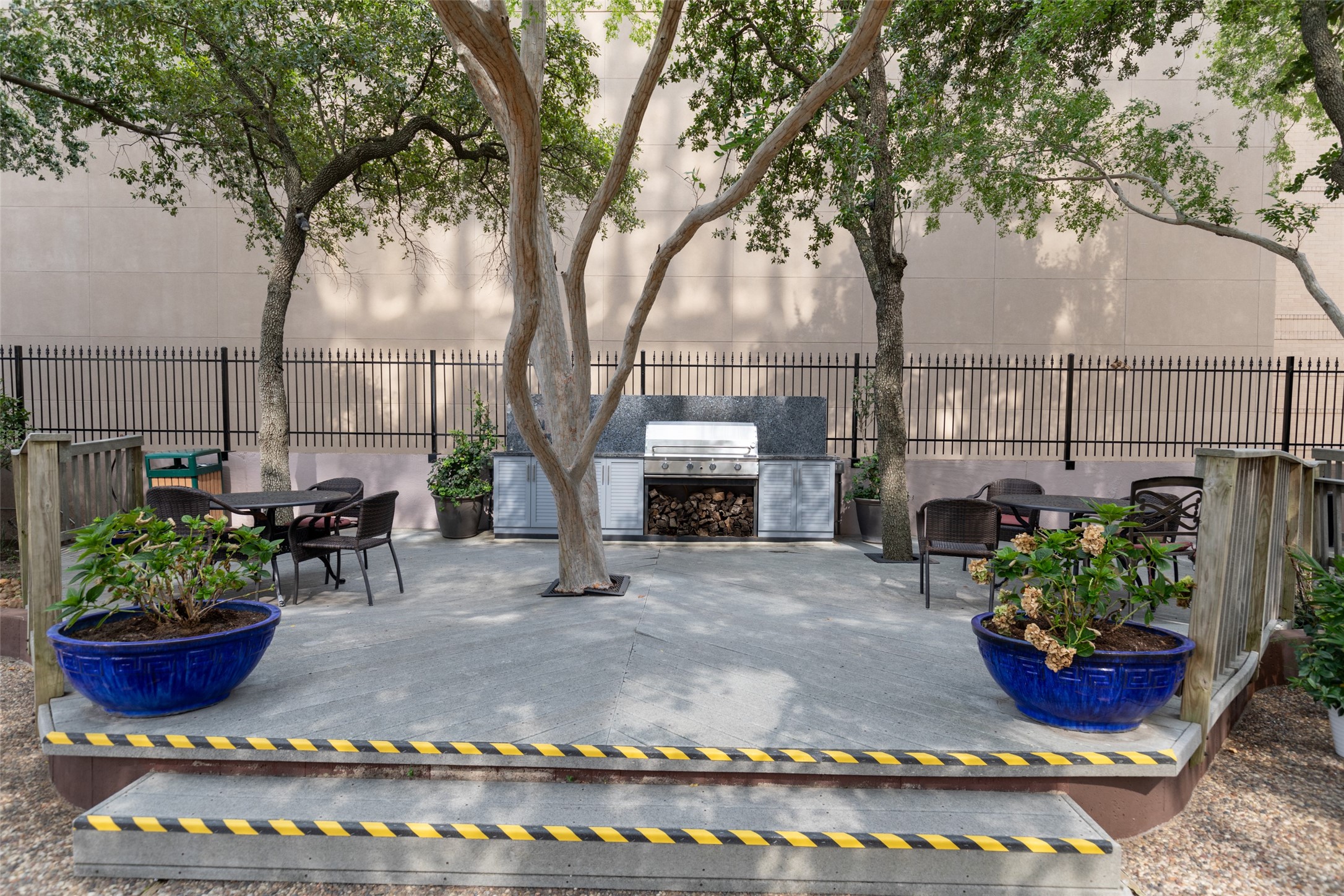 Adjacent to the pool, the summer kitchen area boasts barbecue stations, outdoor seating, and lush greenery, making it the perfect setting for alfresco dining and casual get-togethers.