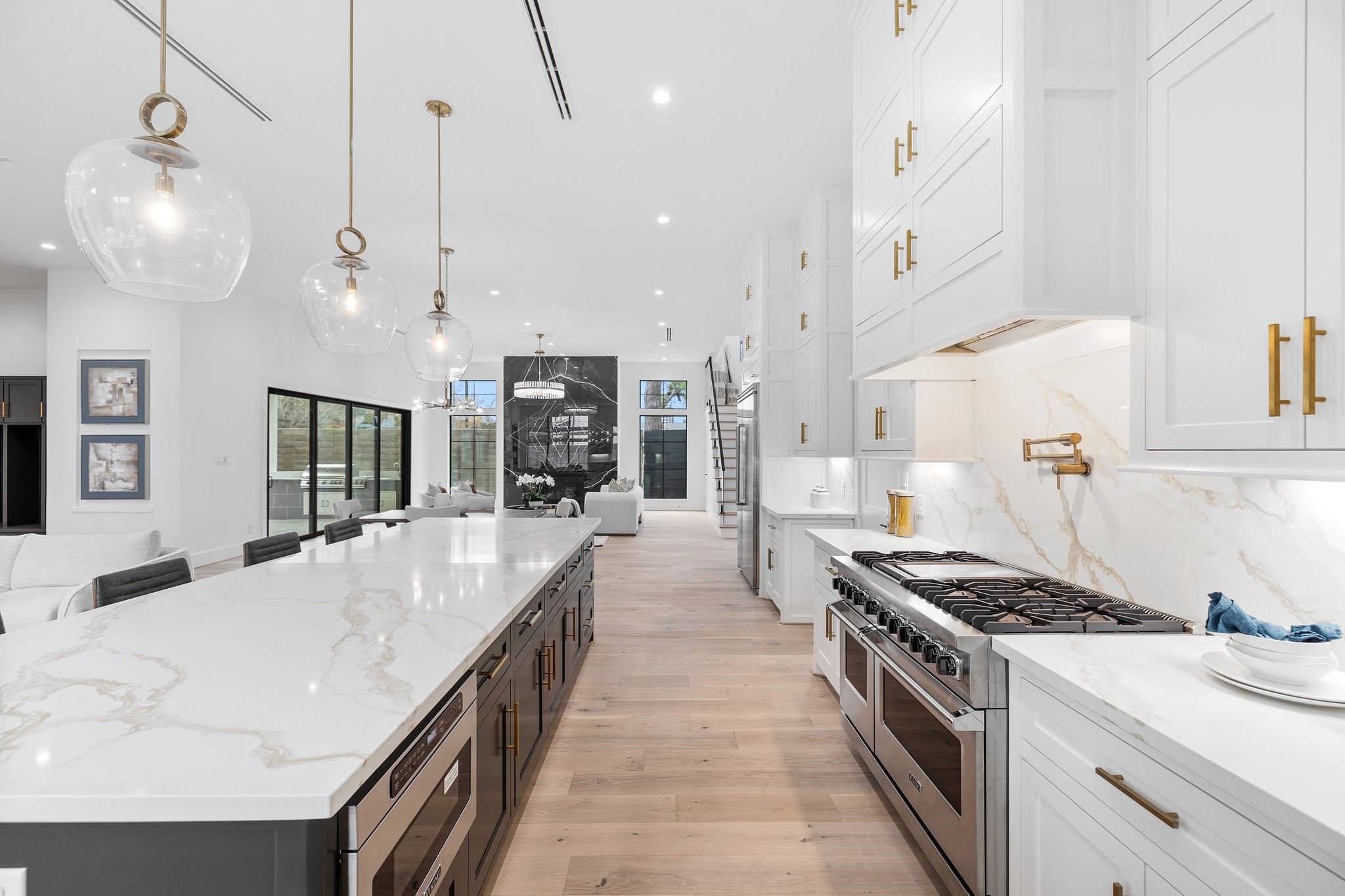 Illuminate your culinary adventures with the soft glow of pendant lights above the island, adding a touch of sophistication. Practicality meets style with under cabinet lighting, ensuring a well-lit workspace for all your cooking endeavors.