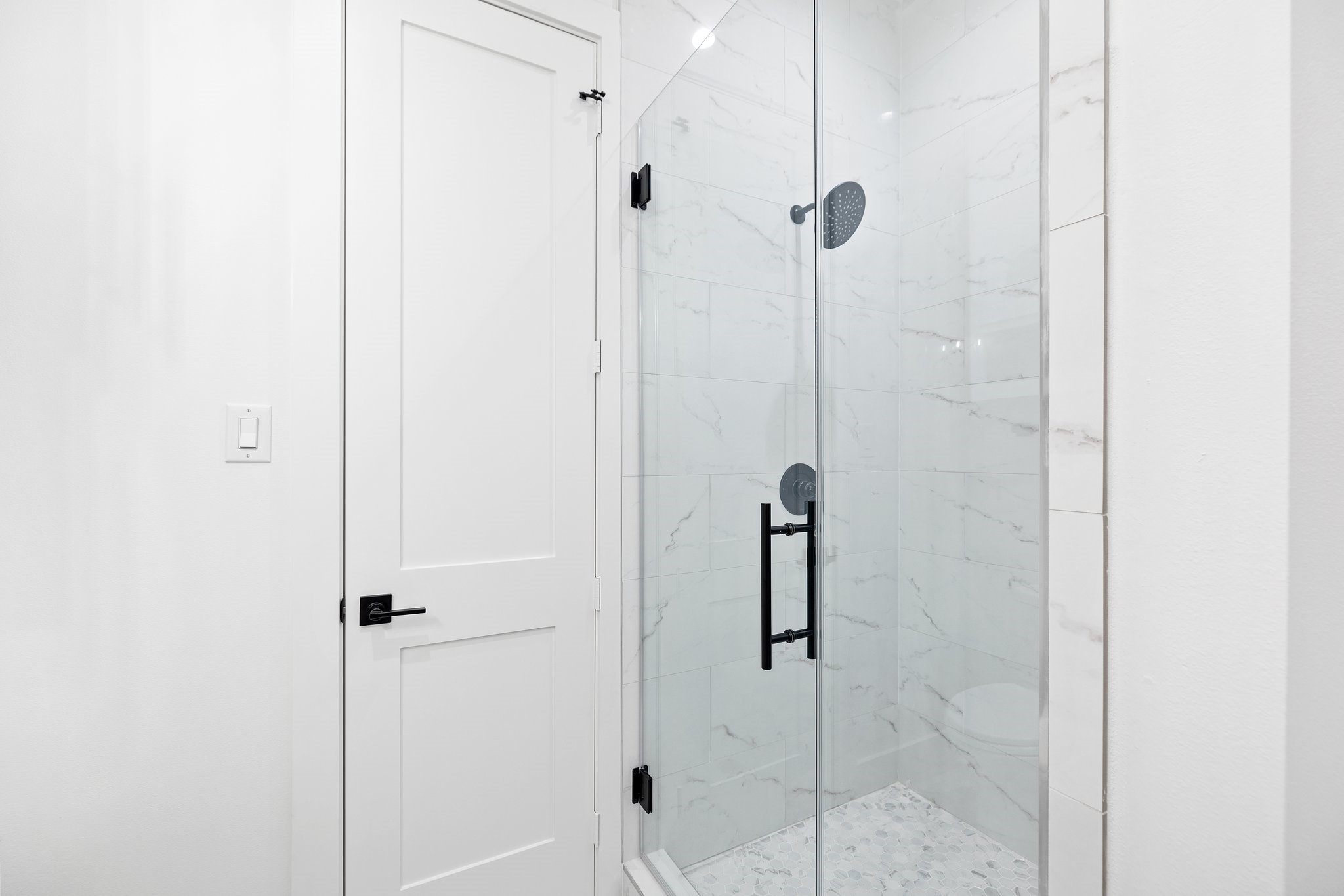This bathroom offers a frameless glass shower, offering versatility for different preferences.