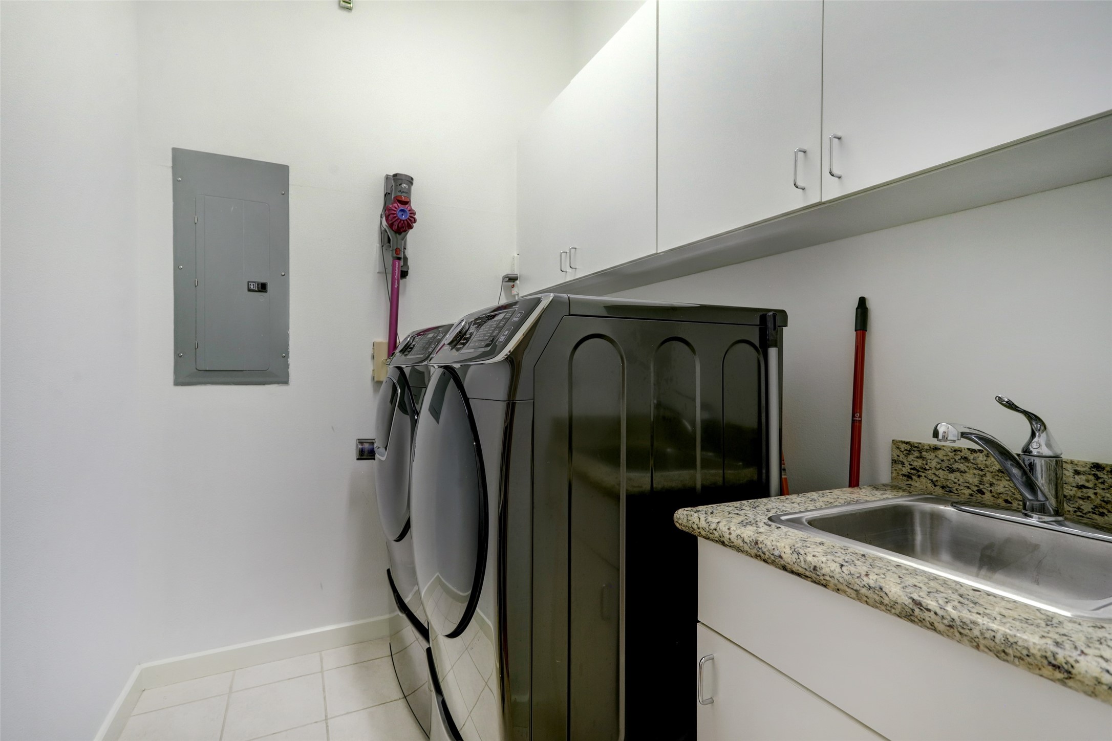 Large utility room with full size washer, dryer and utility sink.