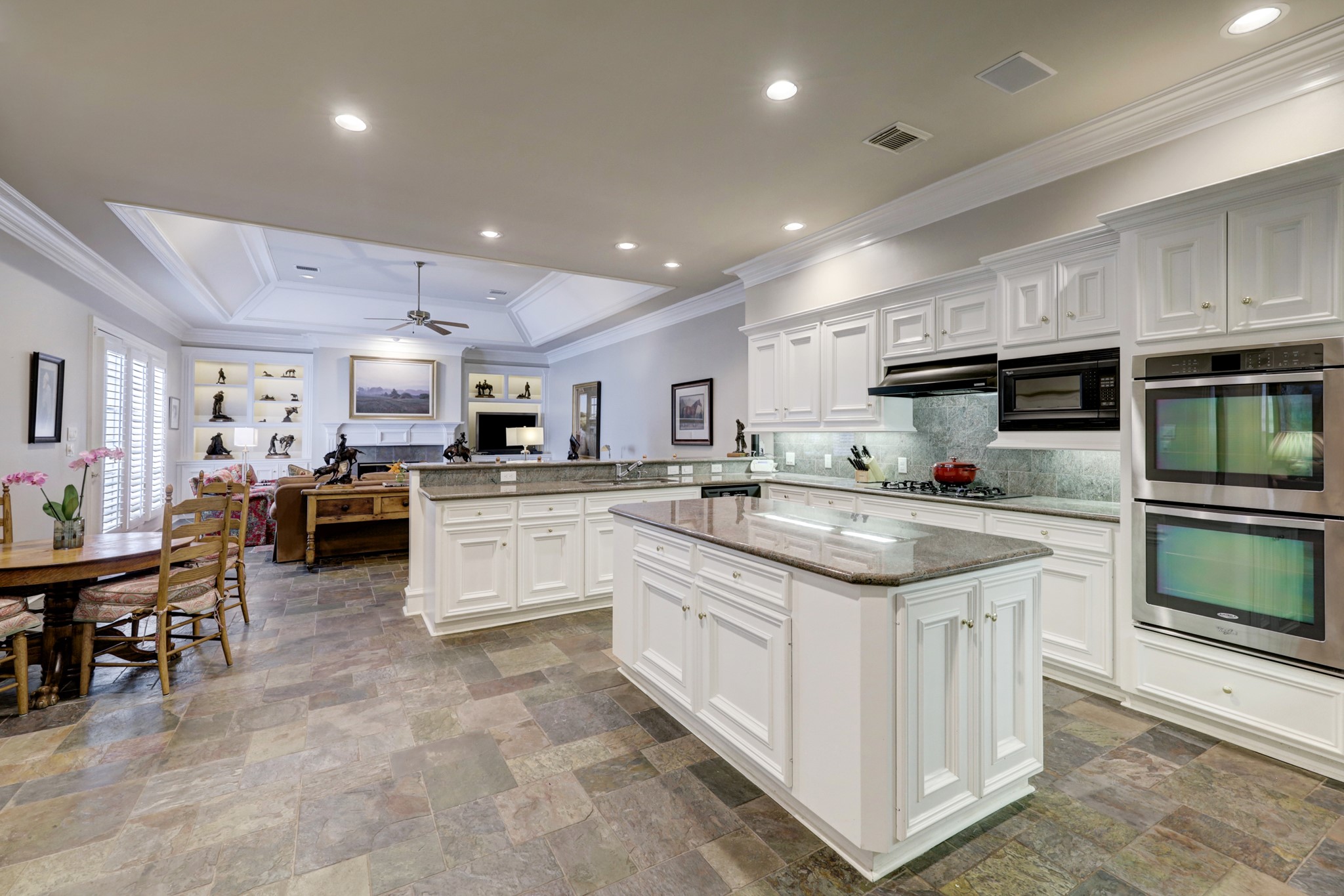 Cook in this delightful Kitchen with granite countertops, sleek slate flooring, and beautiful millwork. 
