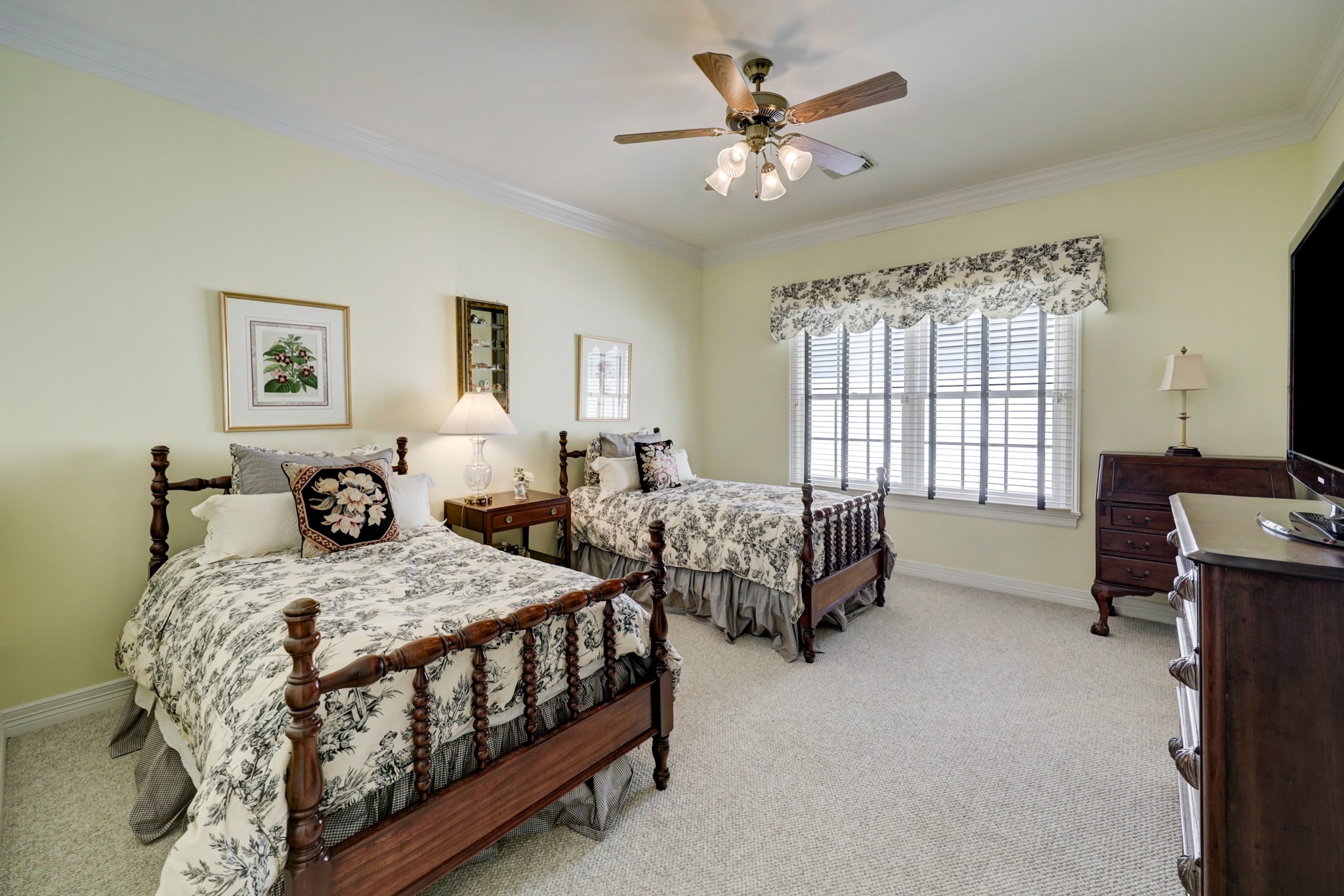 Guest bedroom located on the second floor with en suite bathroom, carpet and walk-in closet.
