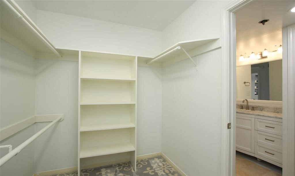 This primary closet is a carefully curated and personalized space to house your essential and favorite wardrobe pieces.