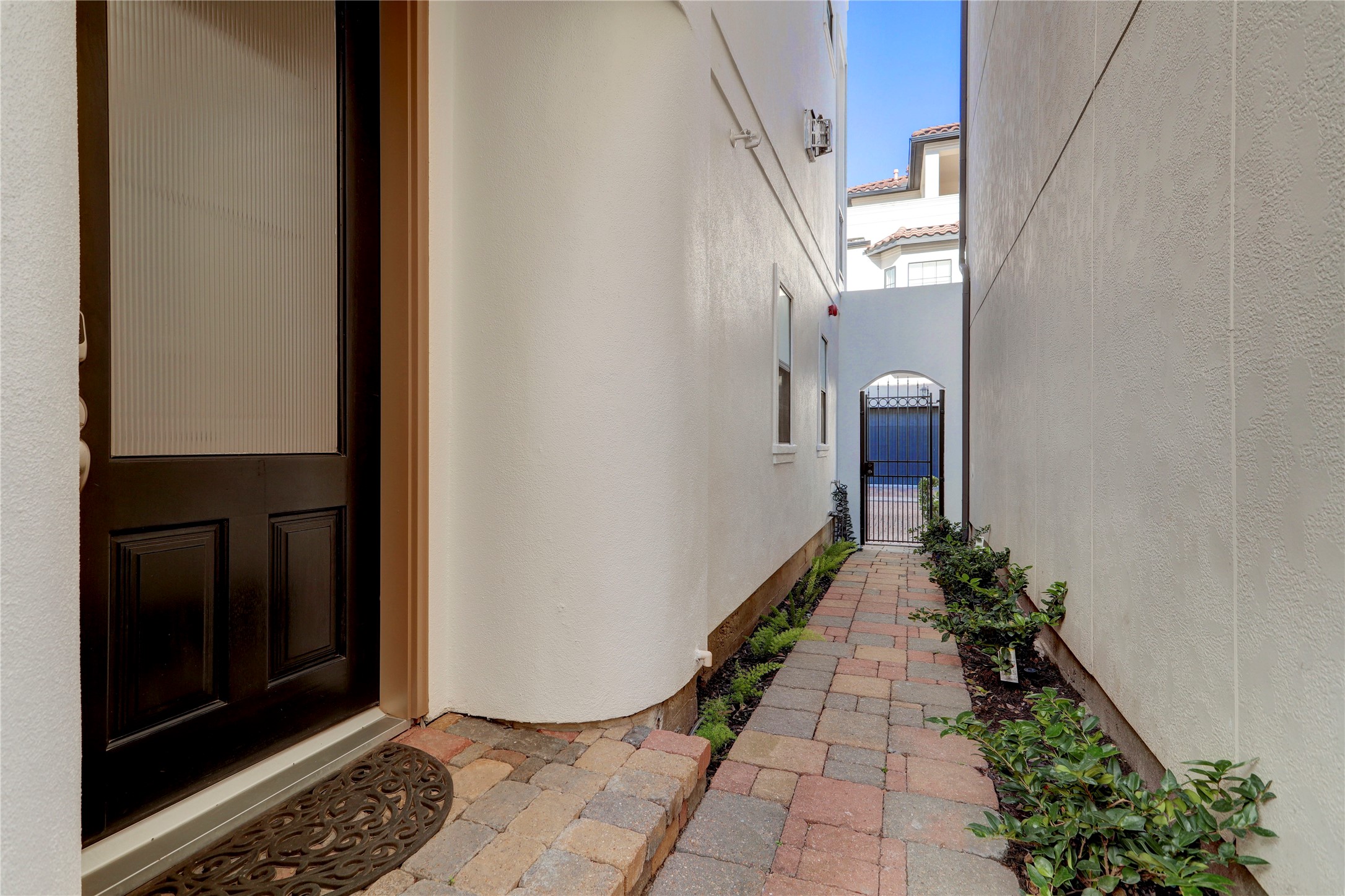 The private walkway to the home is gated, well landscaped and makes for an impressive entry.