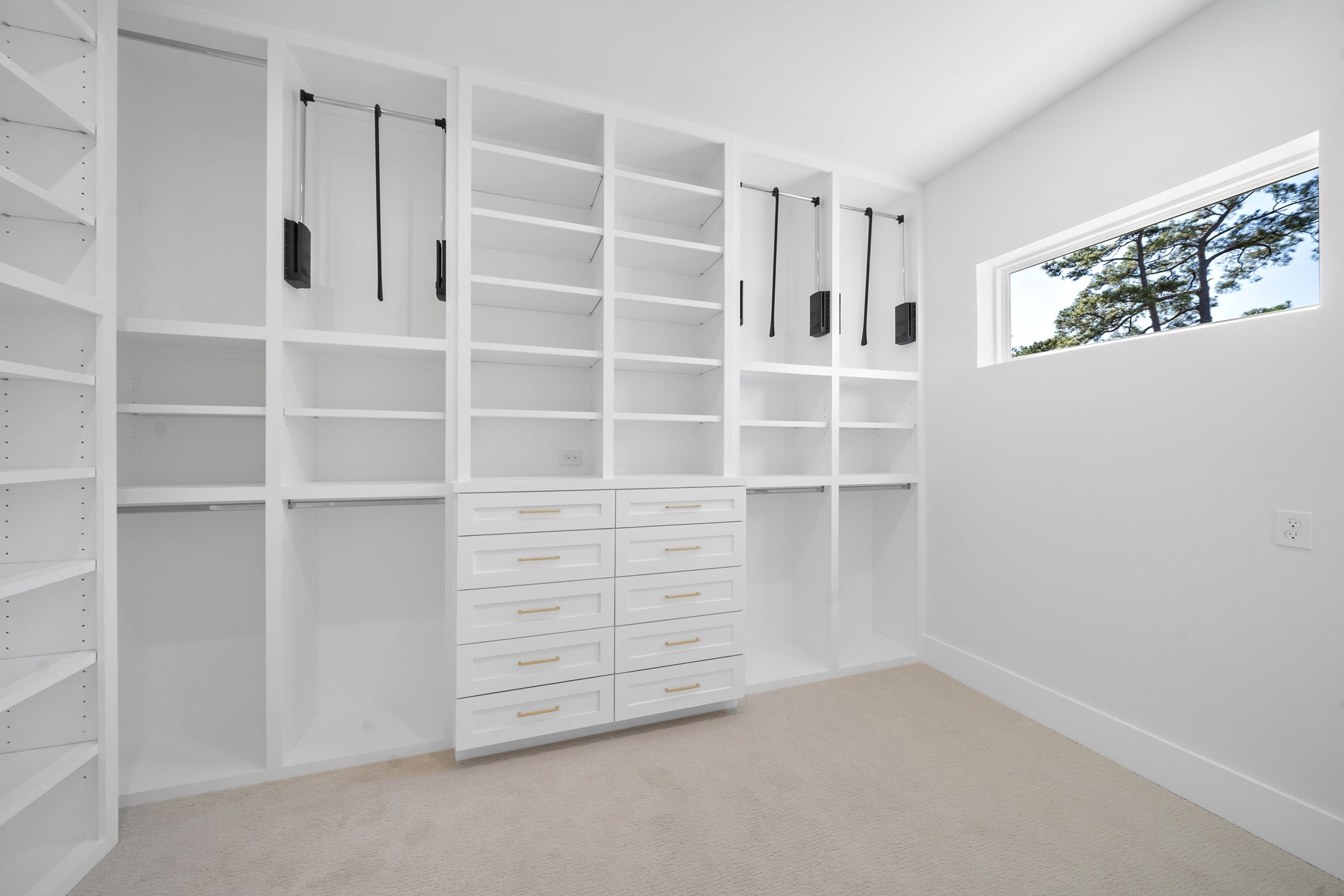organized elegance with this walk-in closet aboundant hanging built in hanging rods, dressing rods and shelving ( with option to put a washer and dryer )