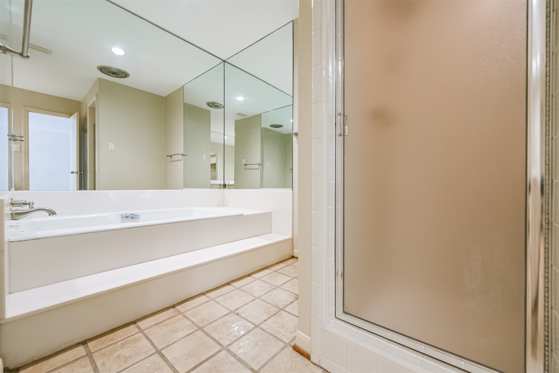 The Primary bath also has this great, long soaking tub and then separate tiled shower.