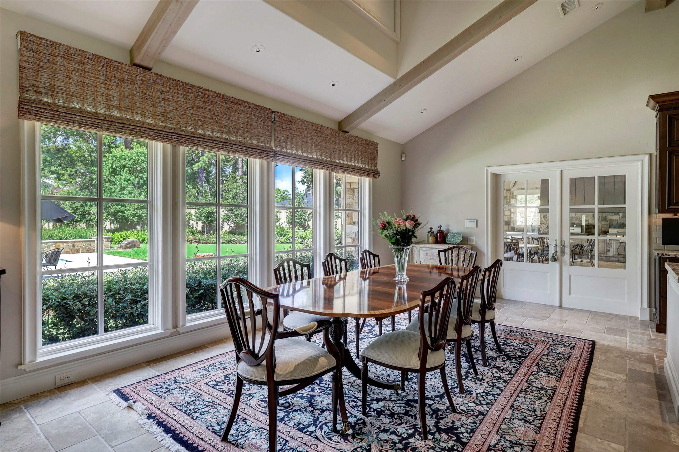 The dining room enjoys views of the lovely landscaping and pool.