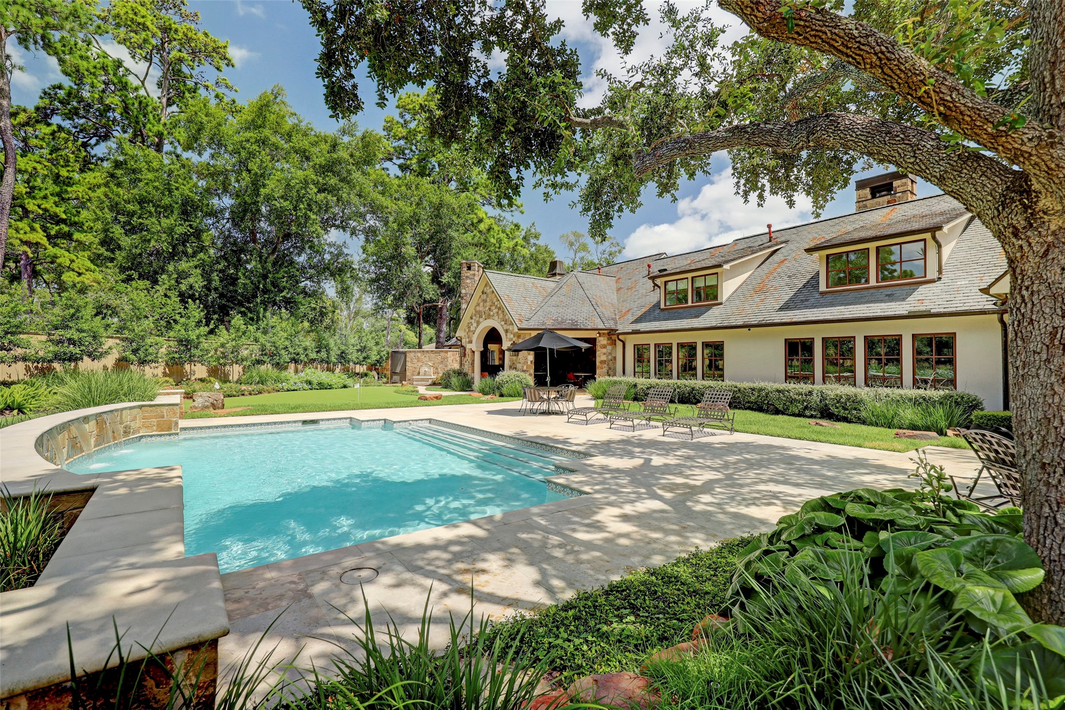 This end of the pool enjoys shade from the large oak tree.