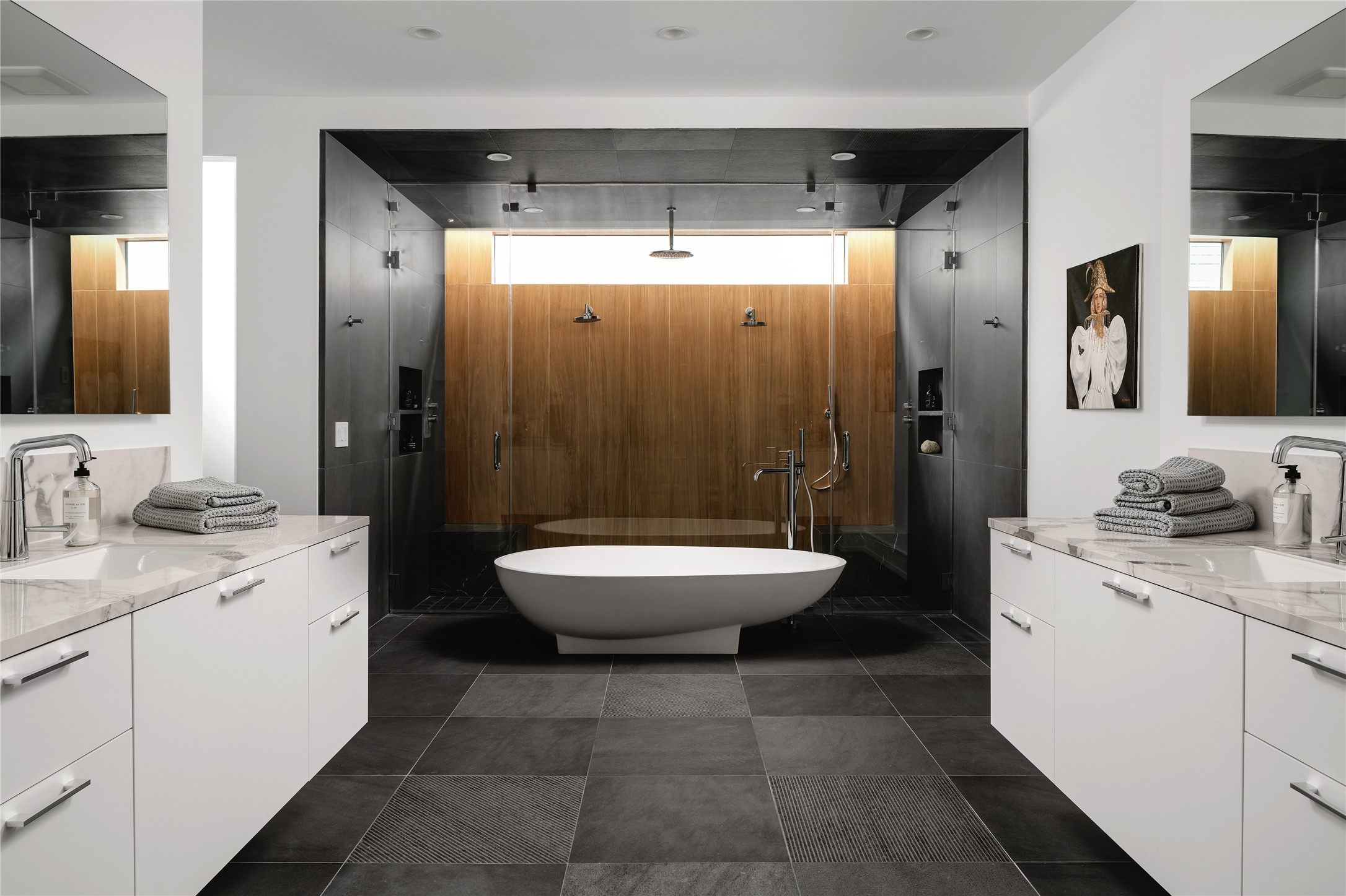 The Iconic Agape Spoon Tub situated in front of the large walk-in shower takes center stage in the en-suite primary bath. Also featured: dual water closets, porcelain counters, backlit mirrors, Italian Nobili faucets and Italian tile. Photos depict when home was previously staged