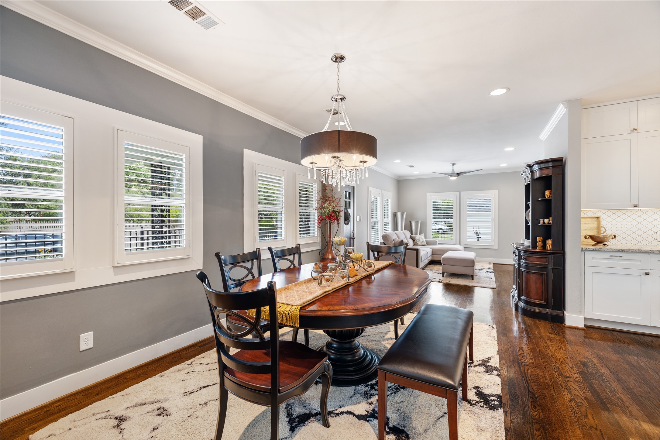 Open to both the living and kitchen, this dining space makes for a great place to entertain. Throughout the home, you will find these new, gorgeous wood shutters designed without tie bars for increased light options and double-pane windows.