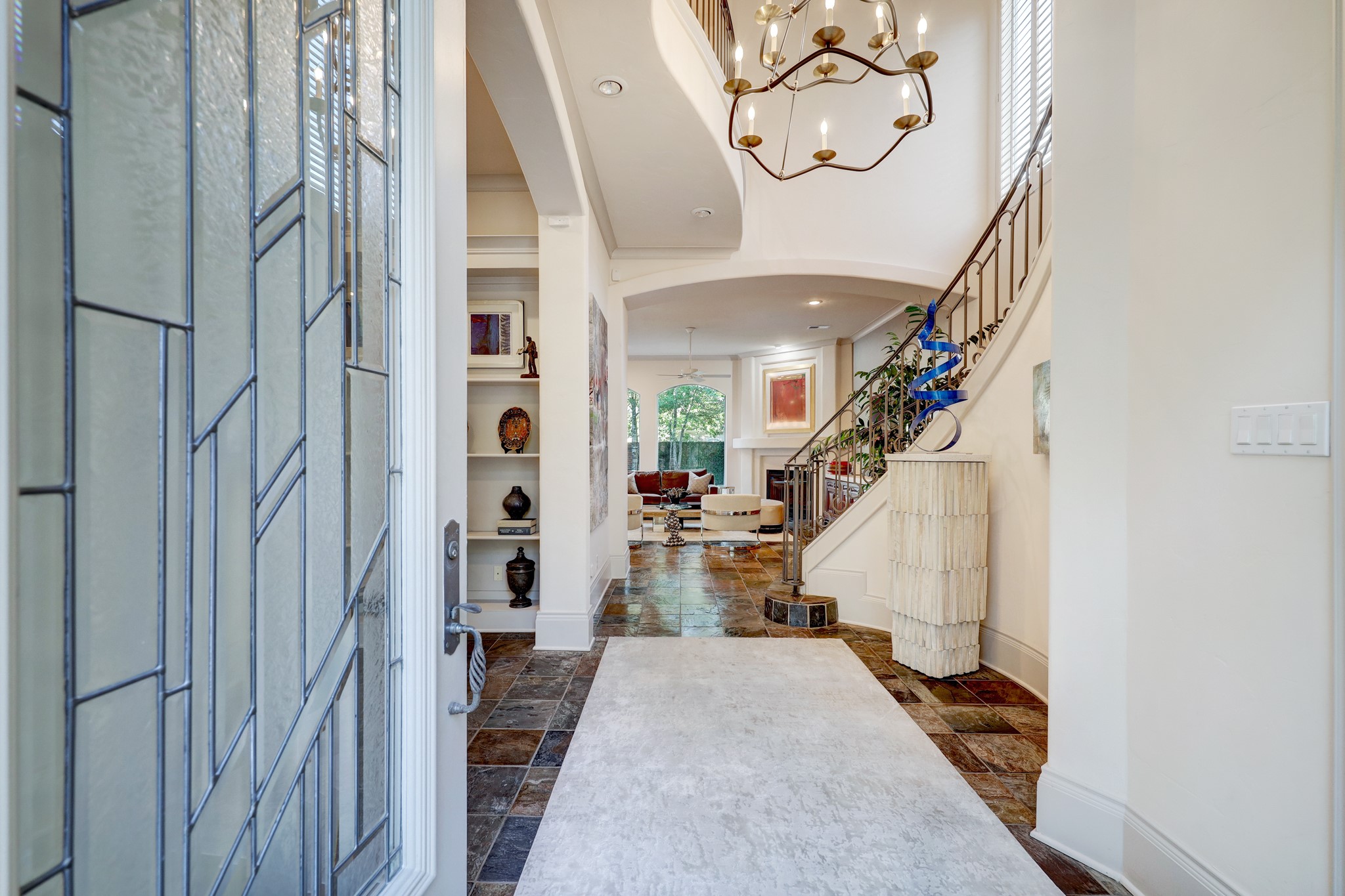Grand entry foyer with soaring ceilings and elegant architectural details, setting the tone for the luxurious and welcoming interior of the home.