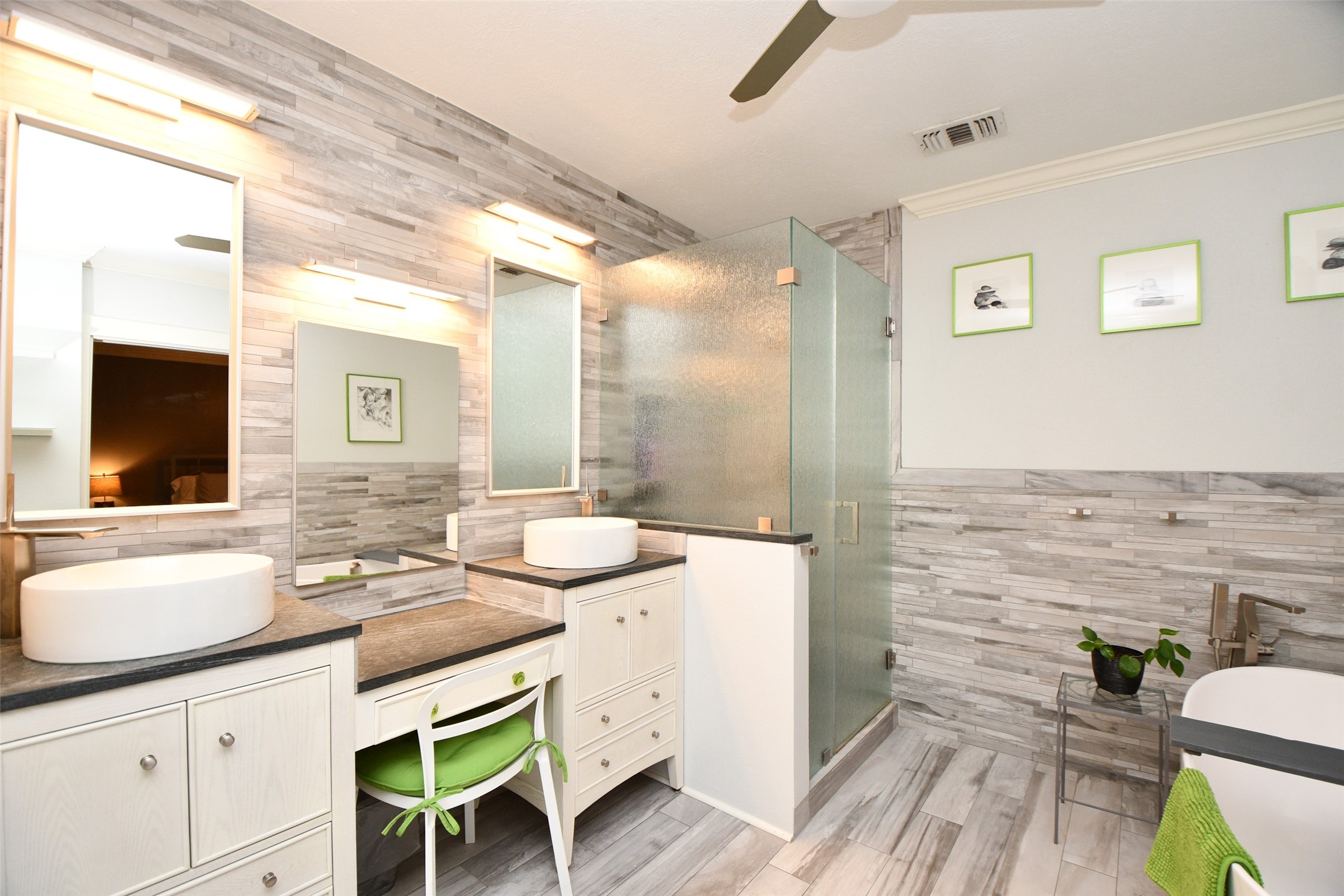 The luxurious primary bath features dual sinks, vanity, stand up shower and separate soaking tub.