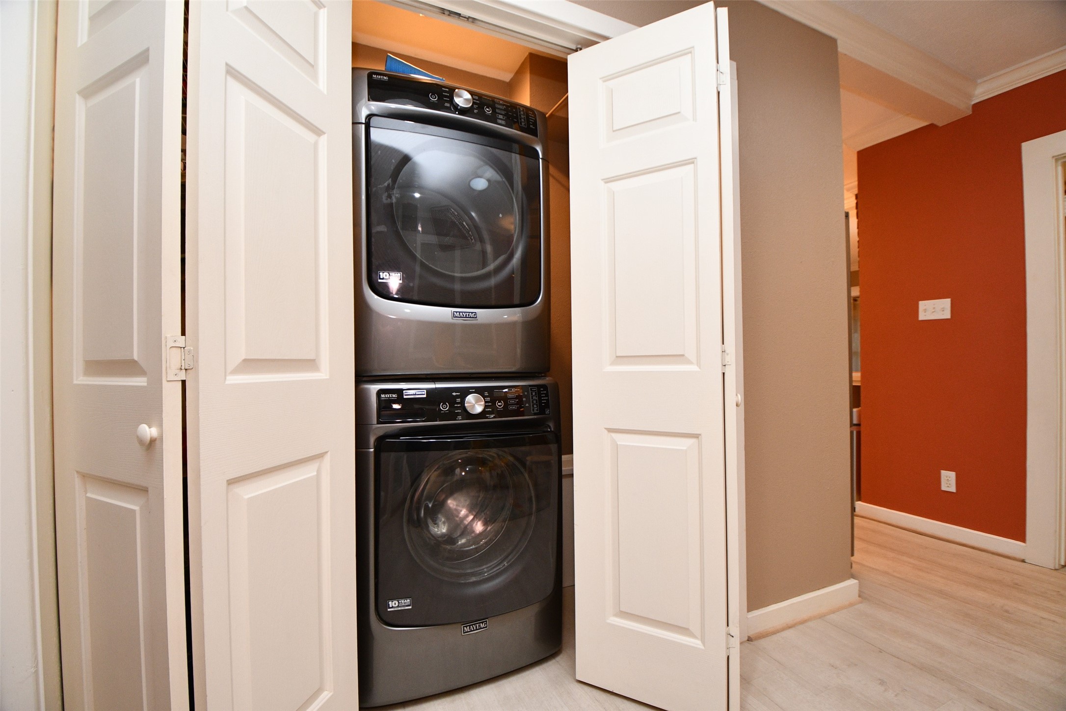 The large utility closet includes this washer and dryer set and is conveniently located next to the primary bedroom.