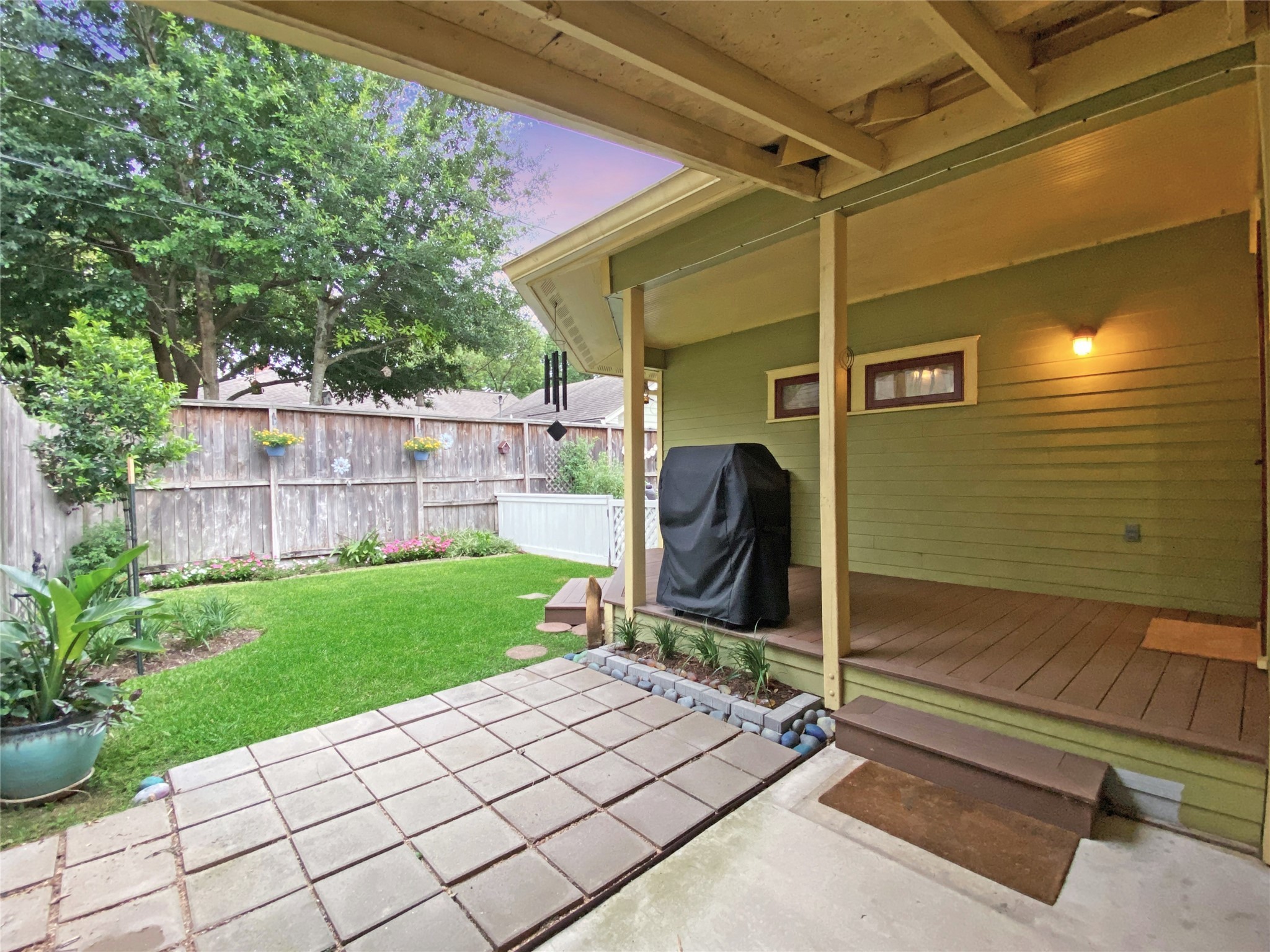 This covered deck next to the covered carport is located just outside of the kitchen and flex room and is your back door.