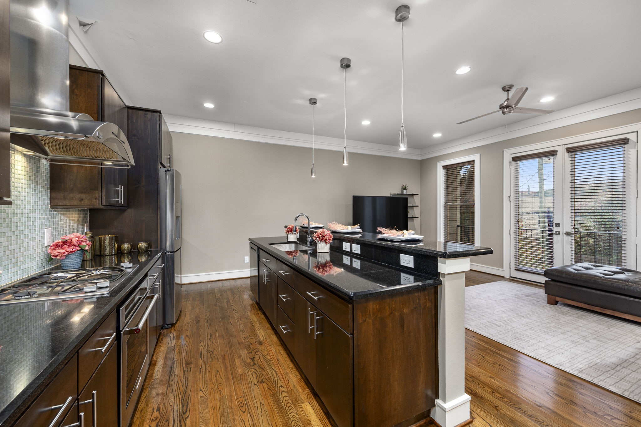 This gourmet kitchen features custom cabinets, recessed & pendant lighting, and granite countertops with a breakfast bar, which allows for extra seating for you & your guests! 322 Patterson St., Houston, TX  77007