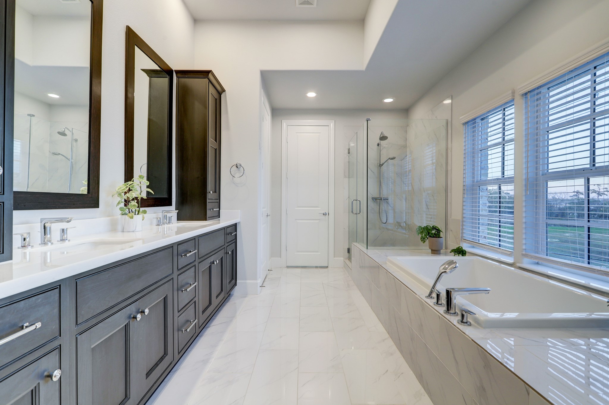 The soothing color pallet and soft finishes of this primary bathroom are genuinely inviting. Wind down the day in the soaker tub complete with a hand held shower wand on the tub-deck. Or enjoy the frameless glass shower complete with a comfort bench.