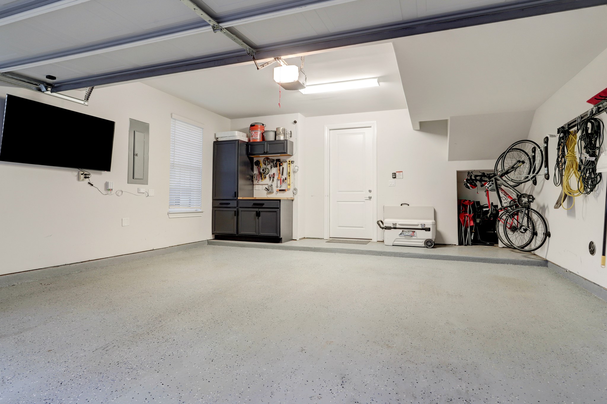 The details are everywhere! Even the garage... with epoxy coated floors, built-in cabinets and an storage nook.