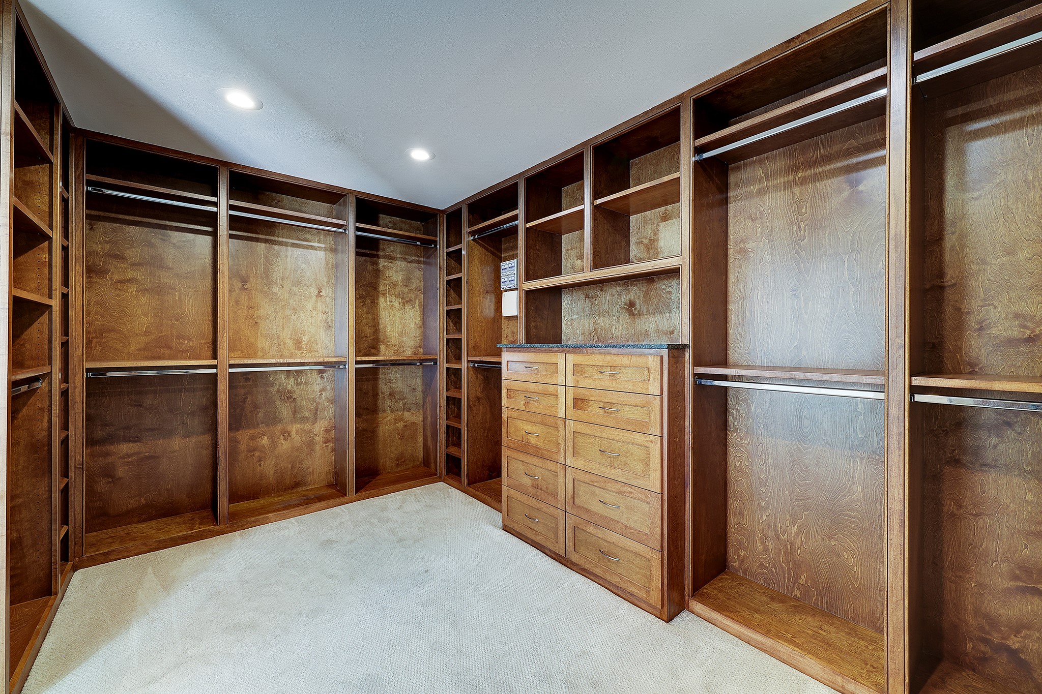 Expansive primary closet featuring meticulously designed built-ins for a wardrobe of any size