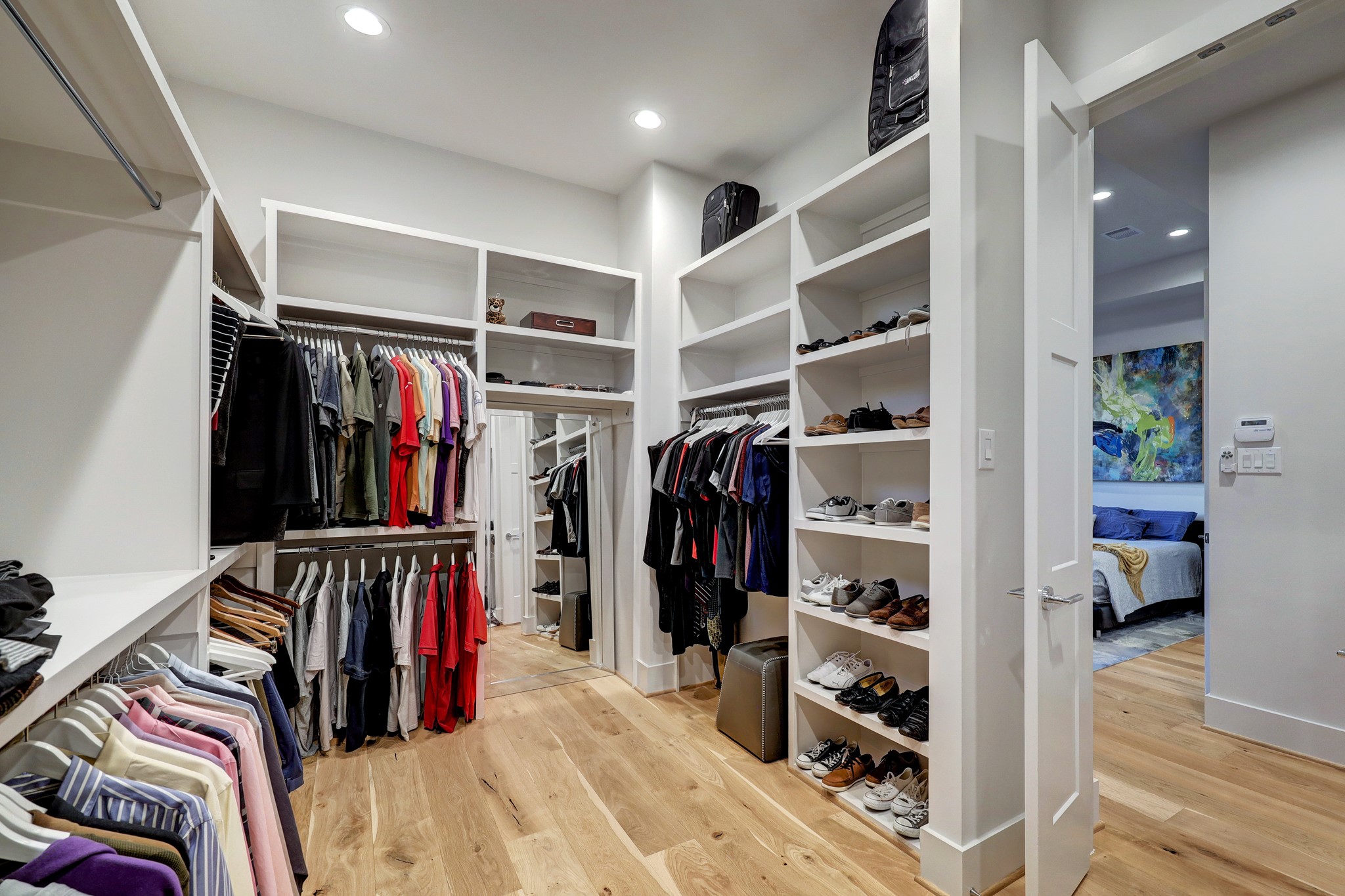 A palatial custom closet tames even the most extensive wardrobes in the beautiful owner's suite.