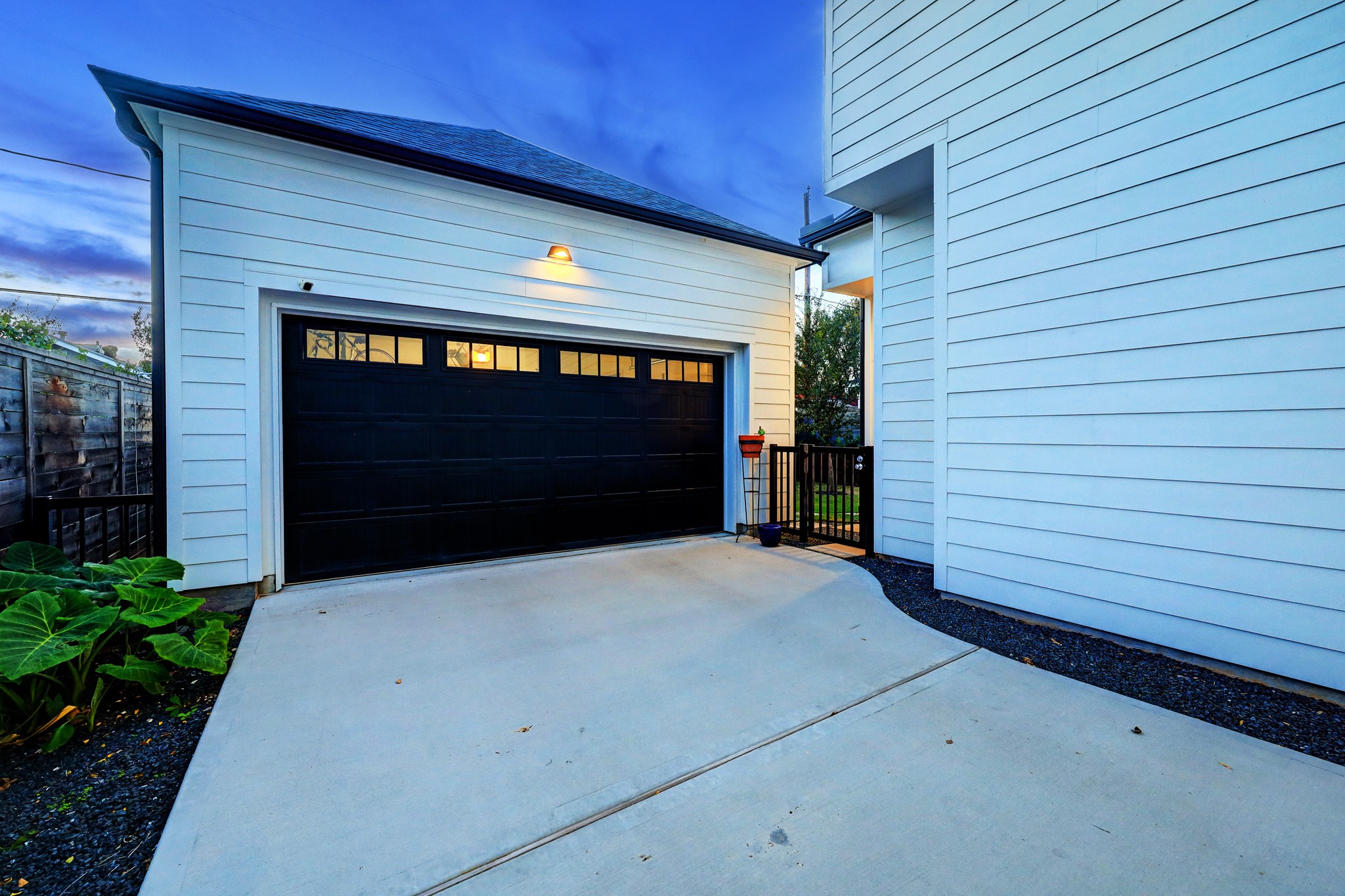 The 2-car garage features epoxy floors and the fully gated driveway does double duty, perfect for additional parking or expanded outdoor entertaining space.
