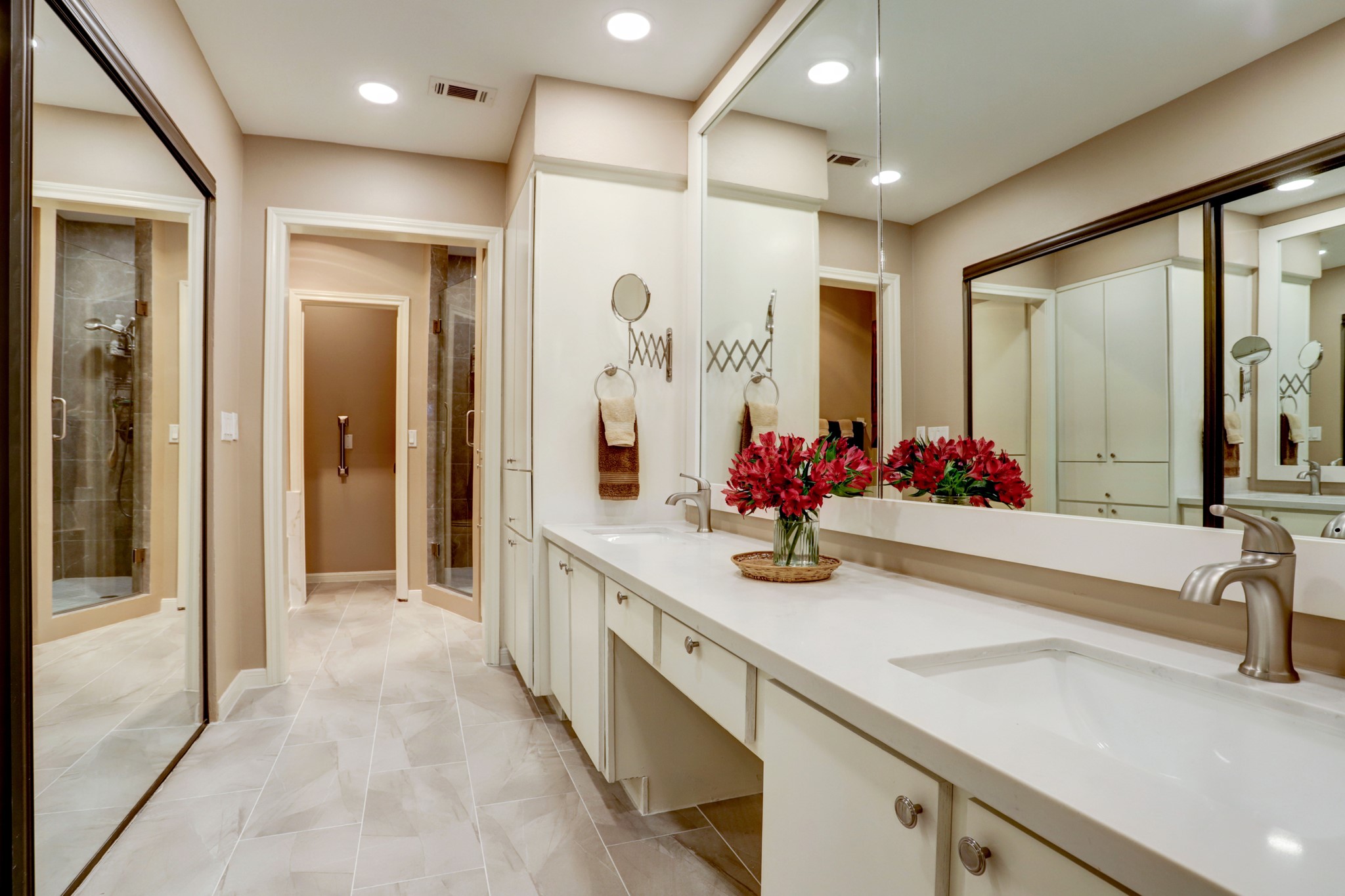 Spacious primary bathroom with double vanity, spa tub and walk-in shower