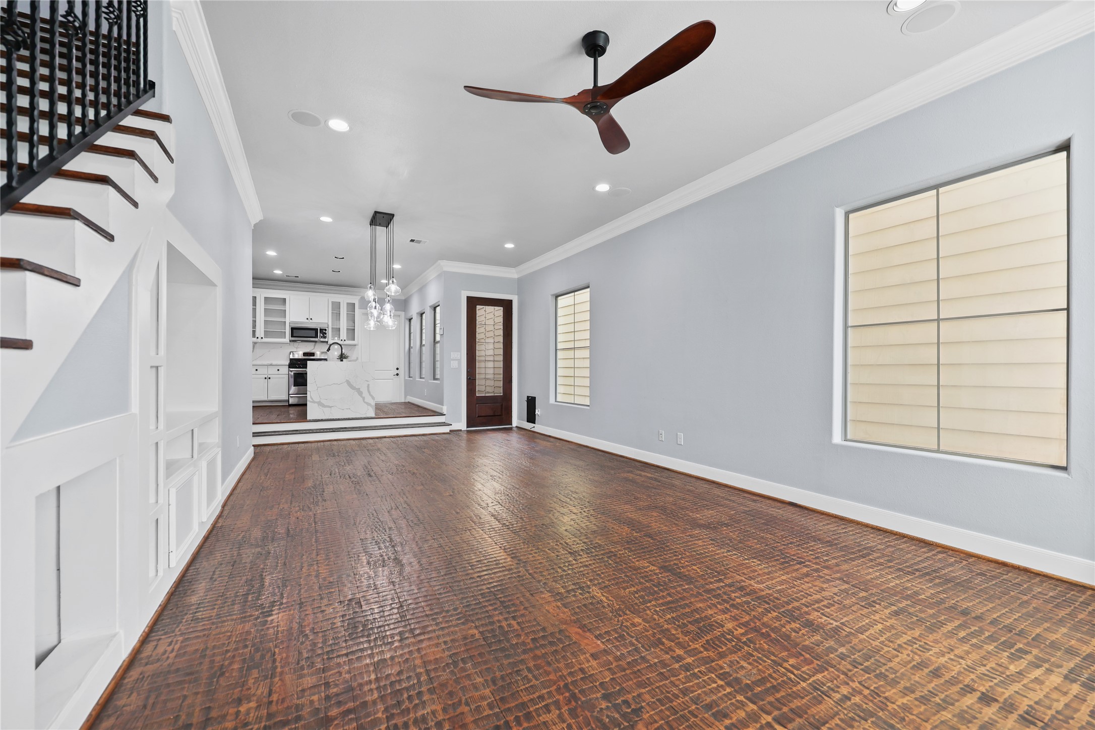 HAND-SCRAPED HARDWOOD FLOORING GRACES THE MAIN LEVEL AND IS ACCENTED BY A CHIC CEILING FAN.