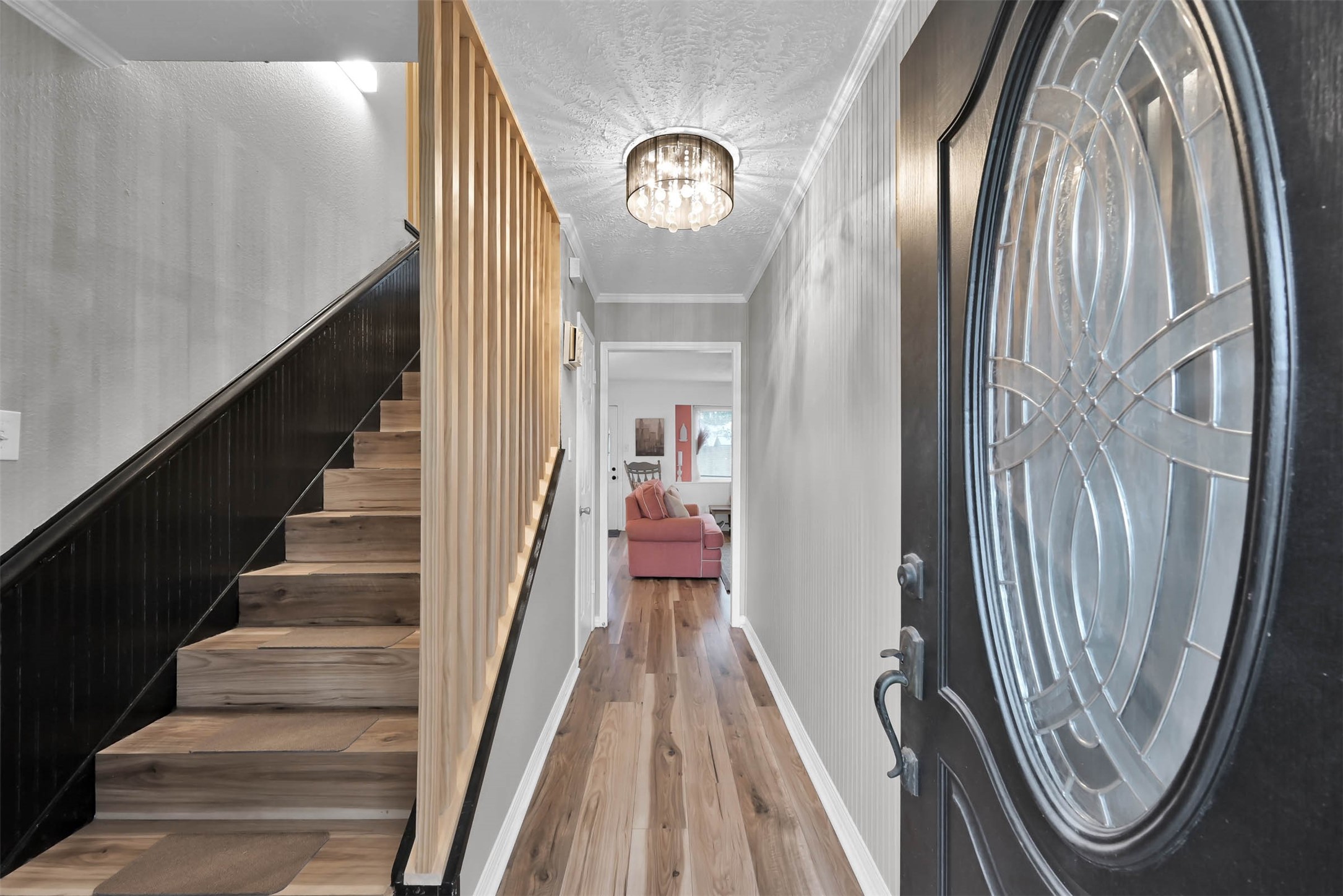 As you enter the home, you will notice the upgraded flooring throughout the first and second floors, including the staircase. The staircase and entry have bead board, a custom stair feature and upgraded light fixture.