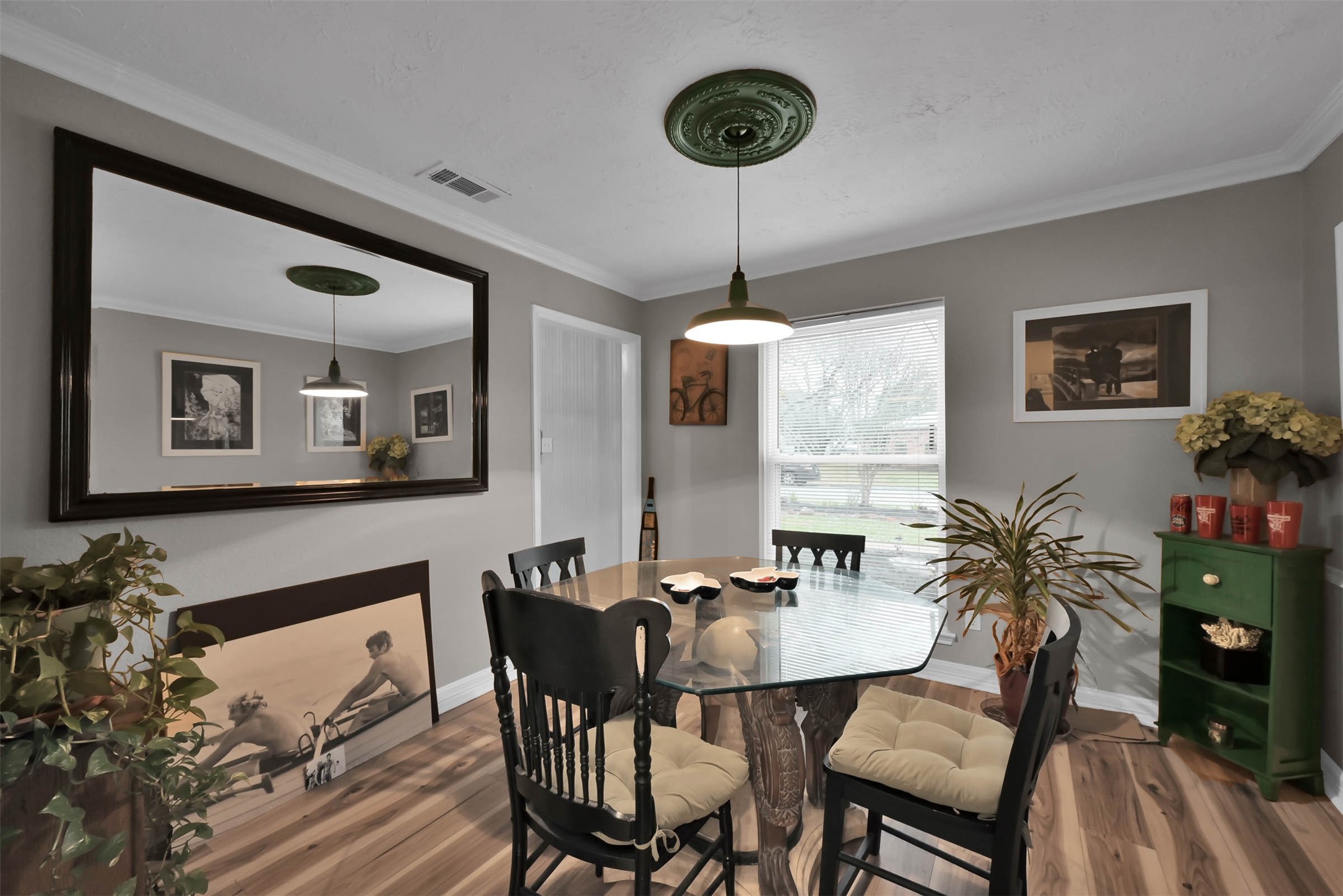 The dining room is convenient to the kitchen and the interior has been painted a neutral greige.