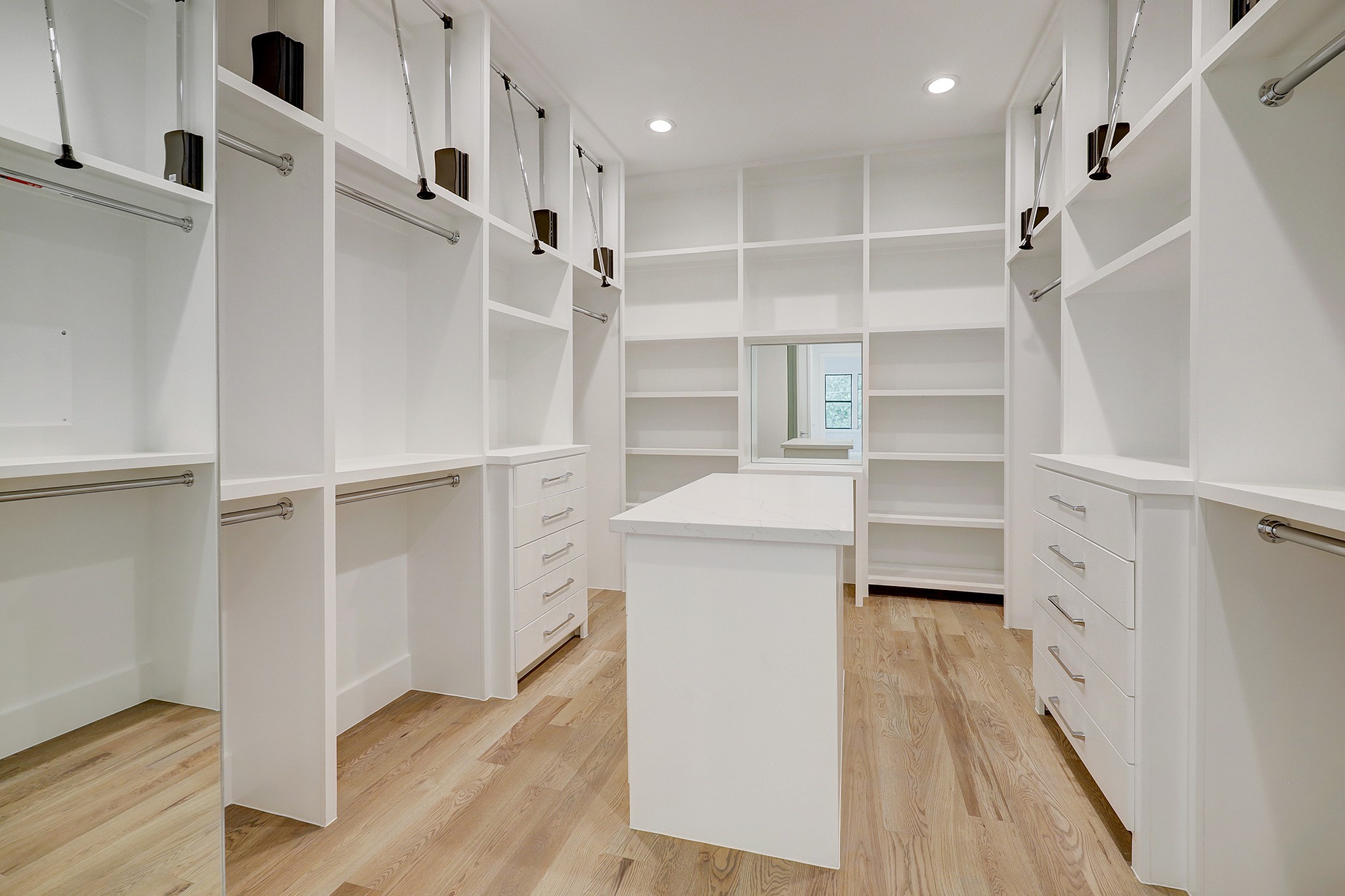 Primary closet with built-in and abundant hanging space