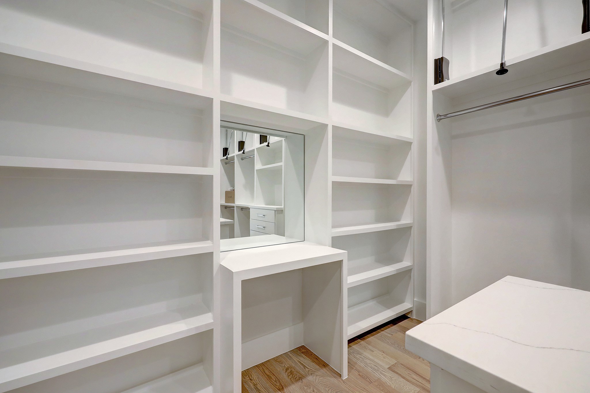 Primary closet with built-in and abundant hanging space