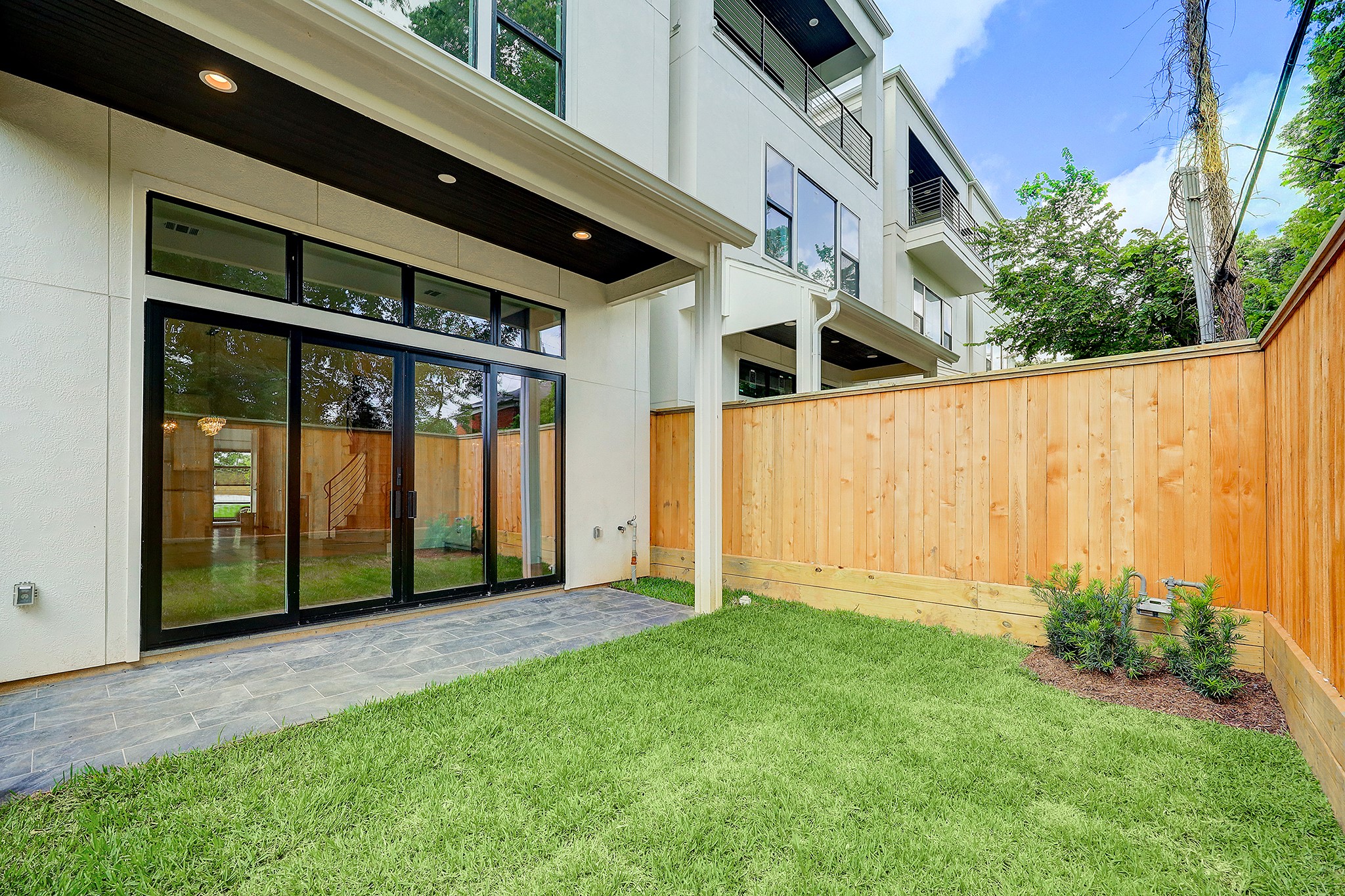 Fully fenced backyard with covered patio