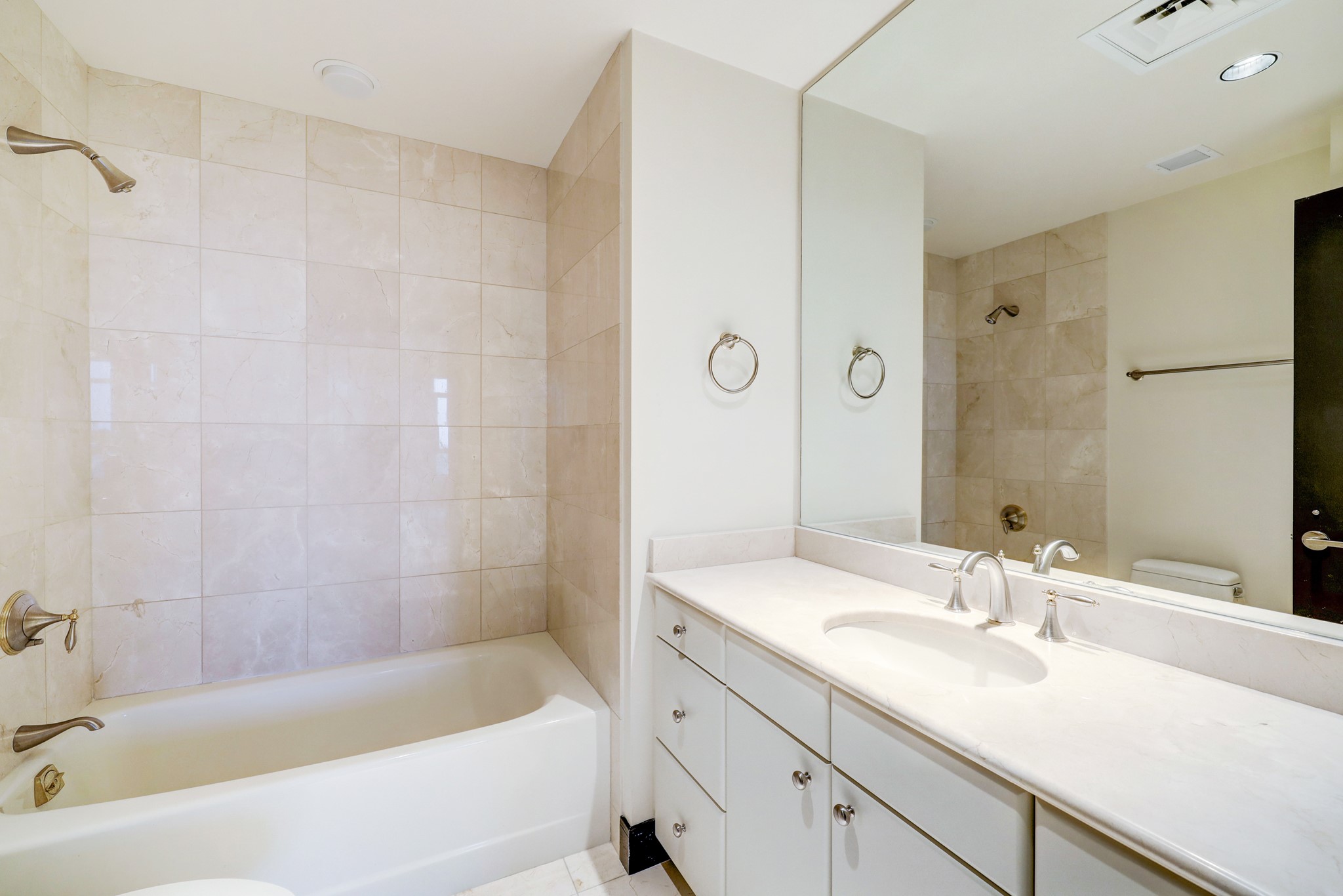 The En-suite Secondary Bathroom features tile floors and walls, and a tub/shower combo.
