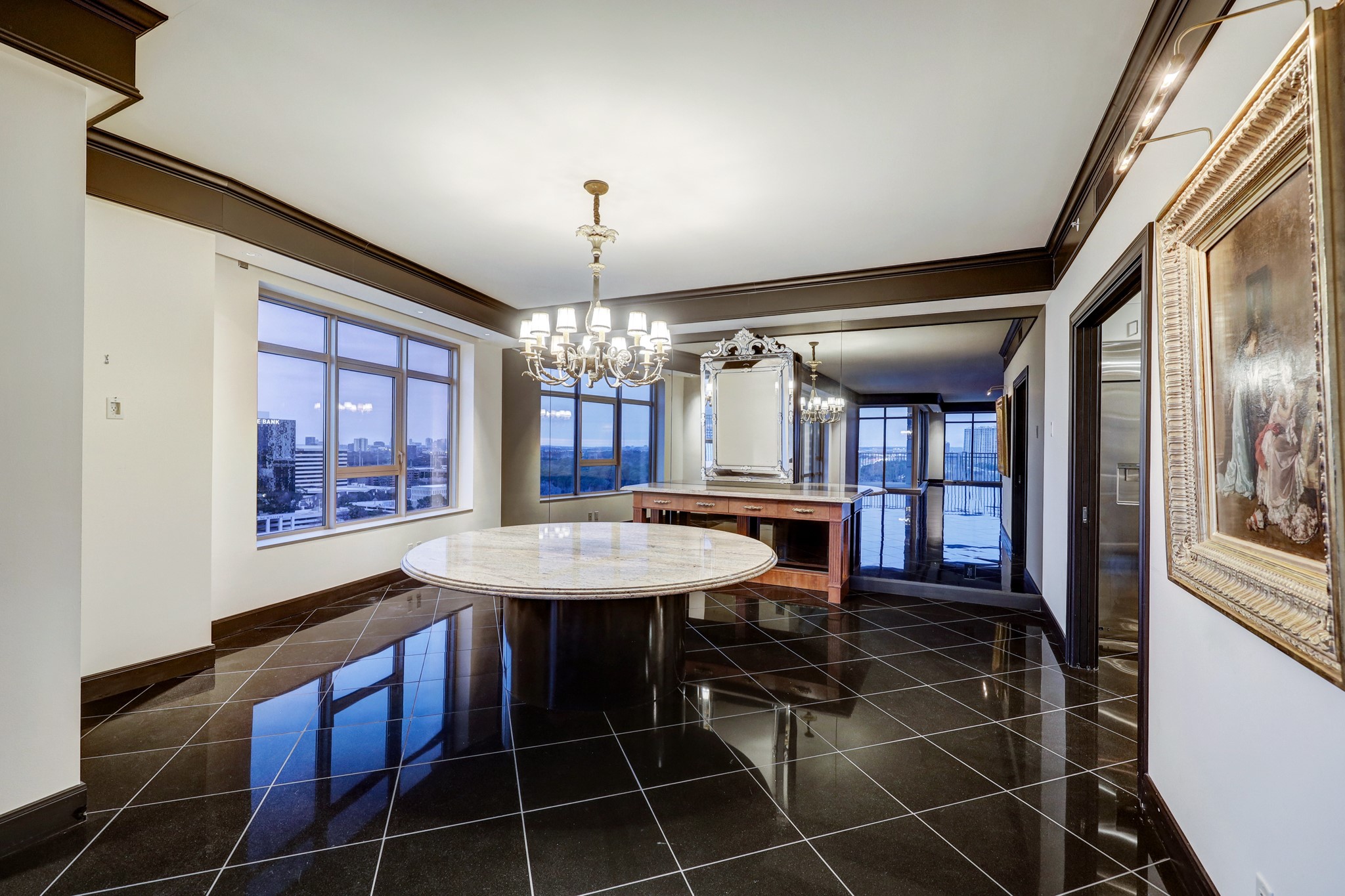 The Formal Dining Room has a mirrored wall, direct access to the Kitchen and is large enough for oversized dining and serving furniture. *Chandelier is excluded, but table and sideboard are available for purchase.