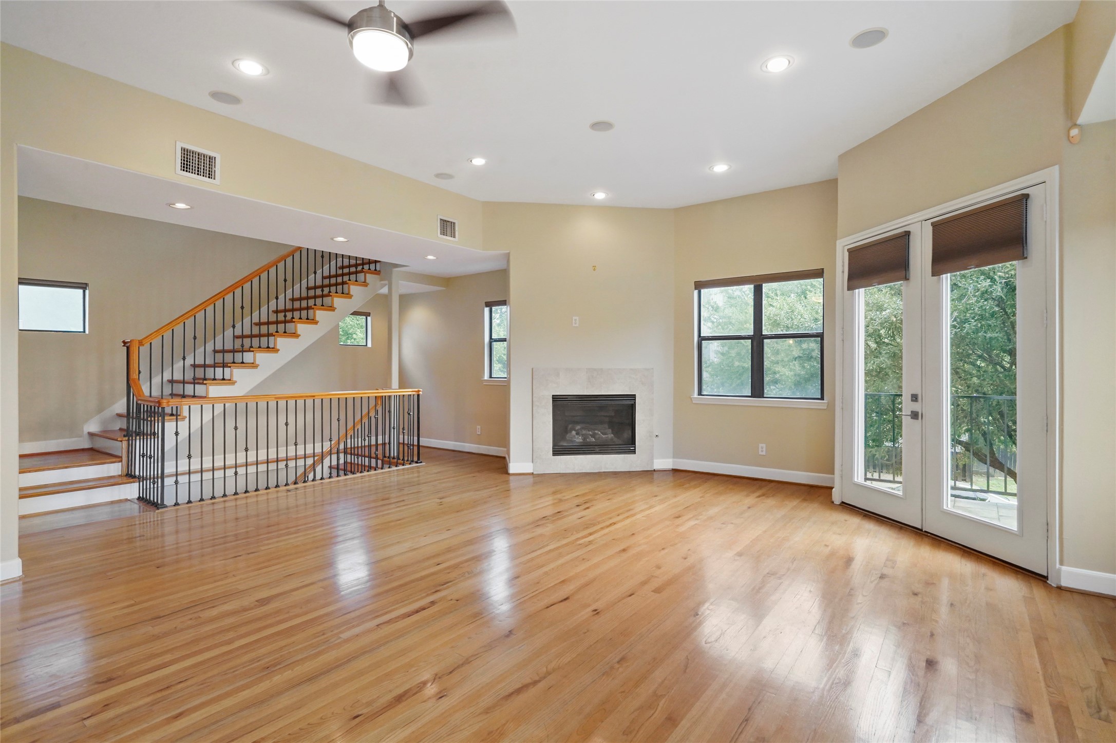Large living area with fireplace and one of two balconies.