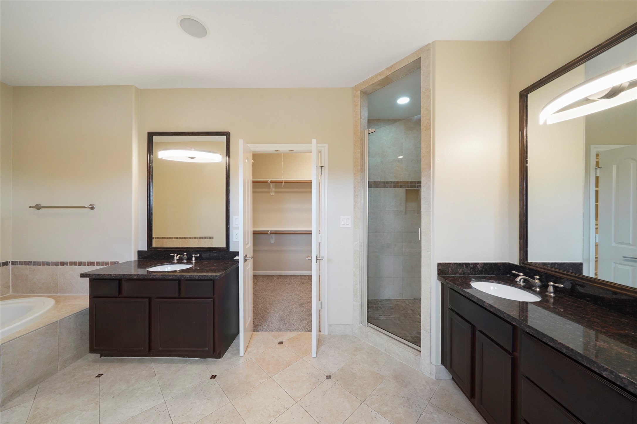 The primary bathroom also offers separate sinks, and jetted tub.