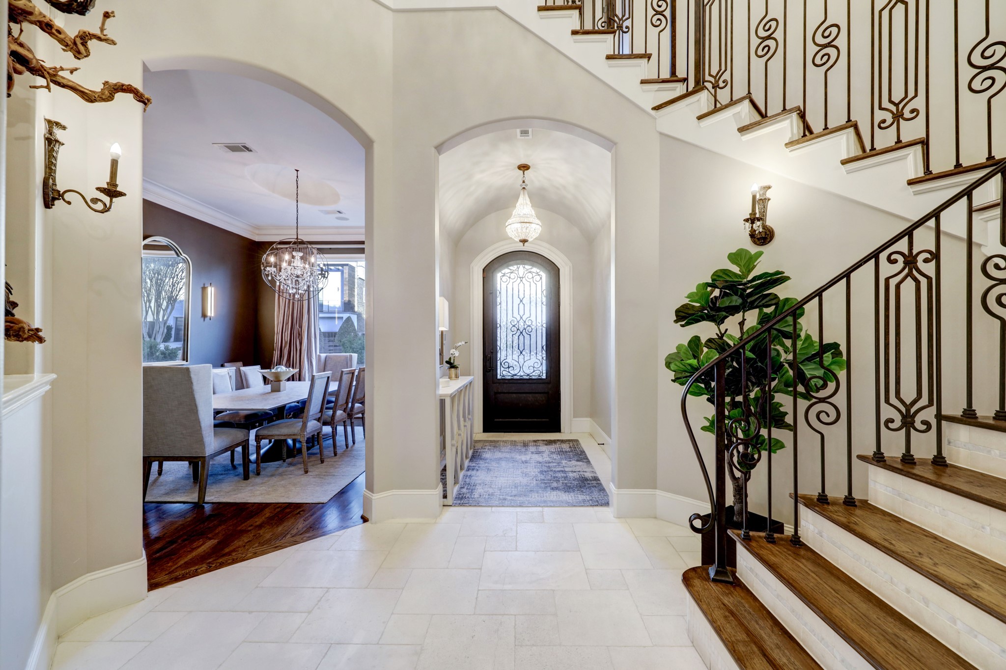 Gracious Foyer with two story ceiling and lighted staircase.