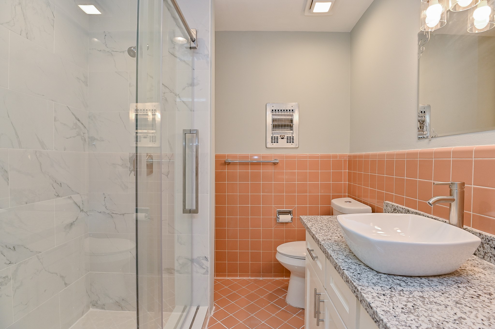 Primary bathroom with recent shower/sink/faucet/vanity/granite countertop/light fixtures.