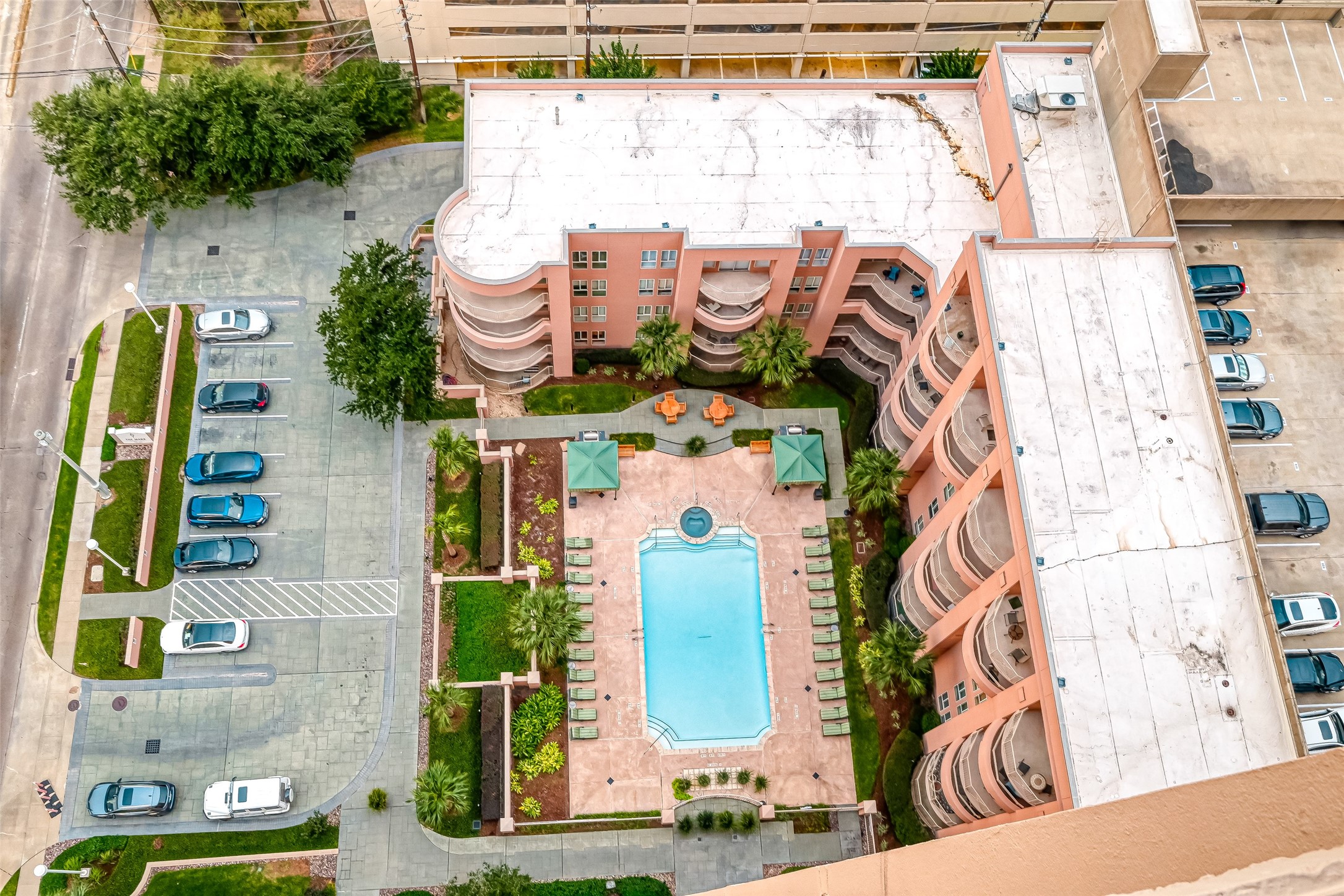 Overhead view of the condo tower and the pool area.