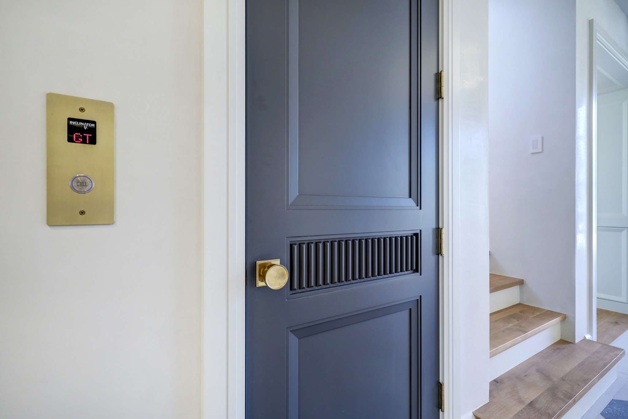 A closer look at the private elevator accented by brass hardware. This elevator is an exquisite touch to this new construction home's livability.
