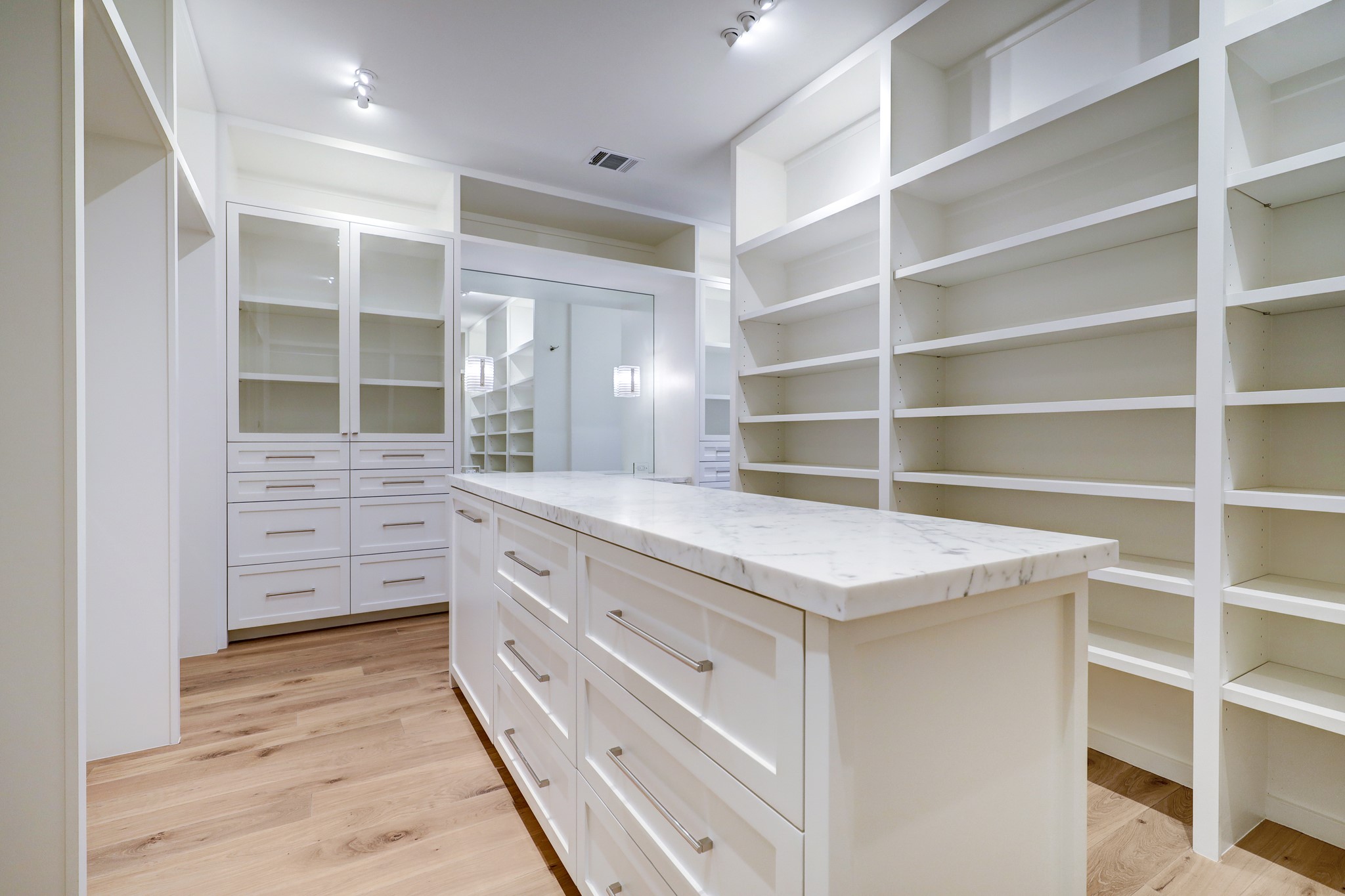 An alternative perspective of the second dressing room unveils a custom vanity separate from the primary bathroom.