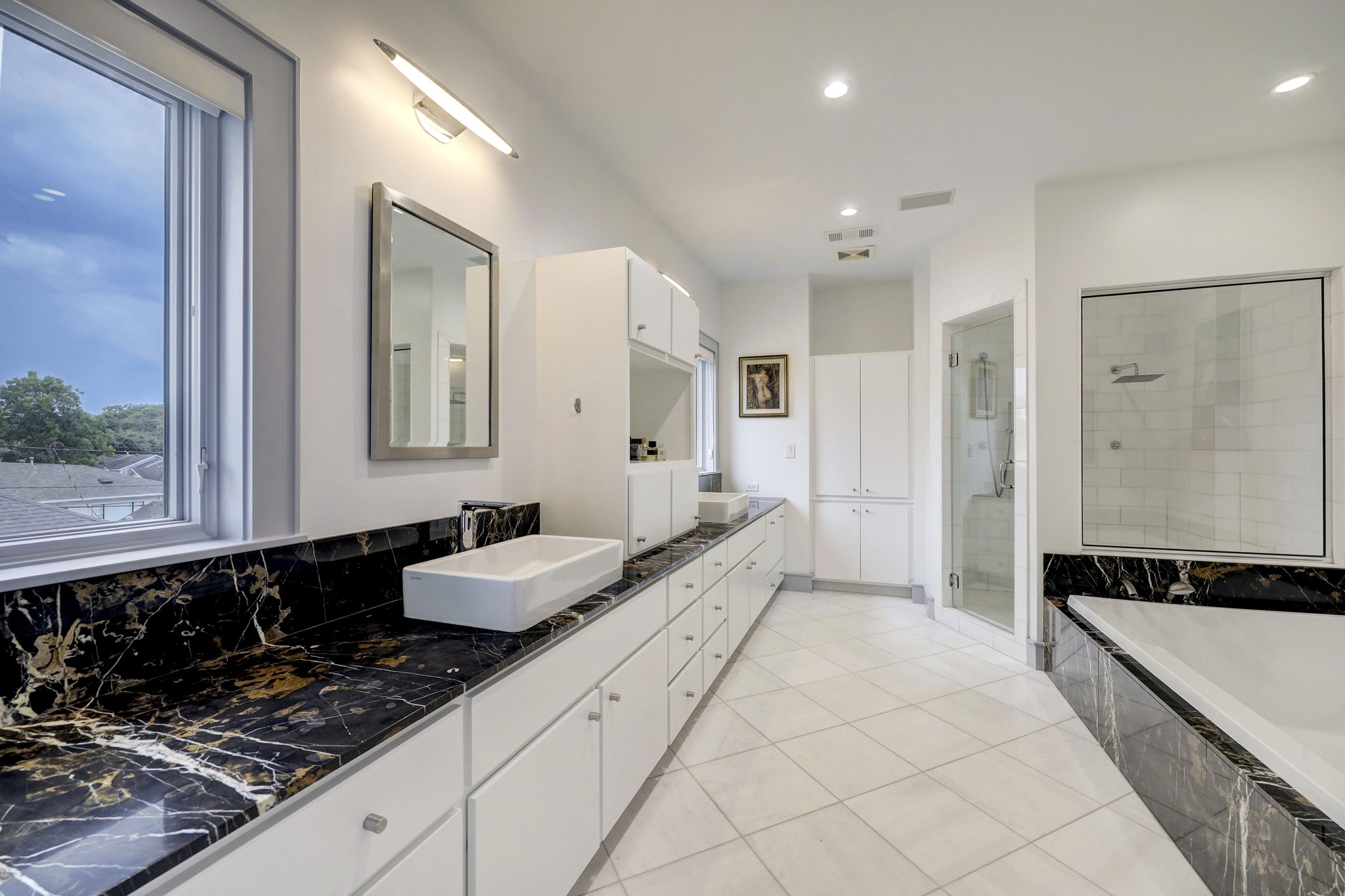 Treat yourself to the spa-like primary bathroom with marble counters, large walk-in marble shower and spacious soaking tub! The primary suite also enjoys a large walk-in closet. 

