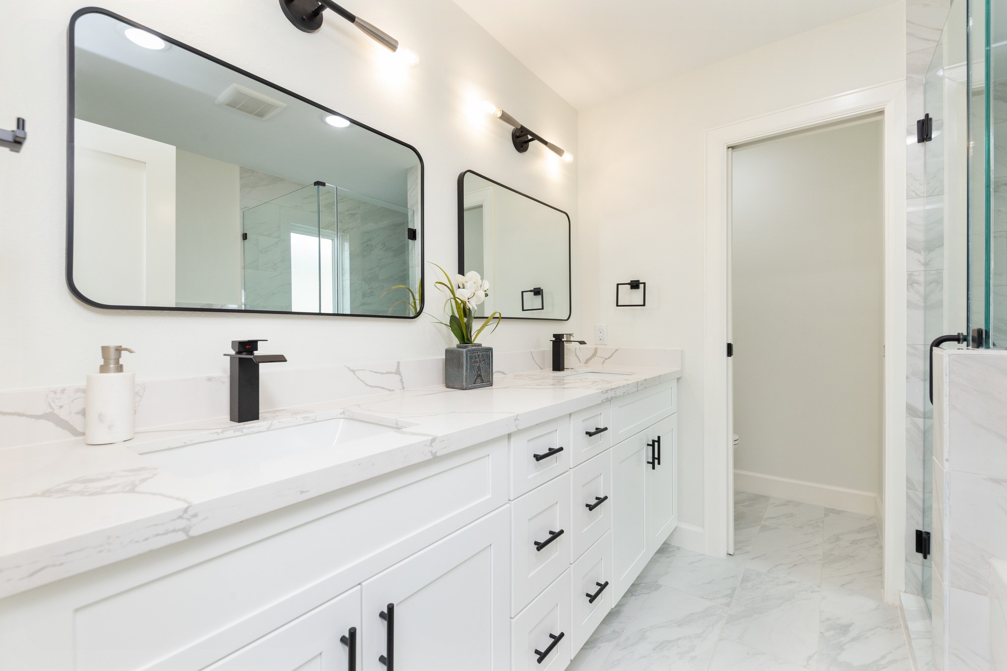Primary bathroom features double vanities, large shower & spa like tub