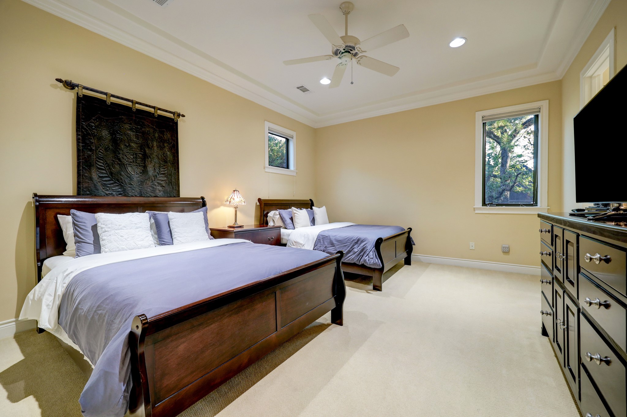 This Secondary Bedroom [17 x 13] features carpet, crown molding and baseboards, a walk-in closet and en-suite bathroom.