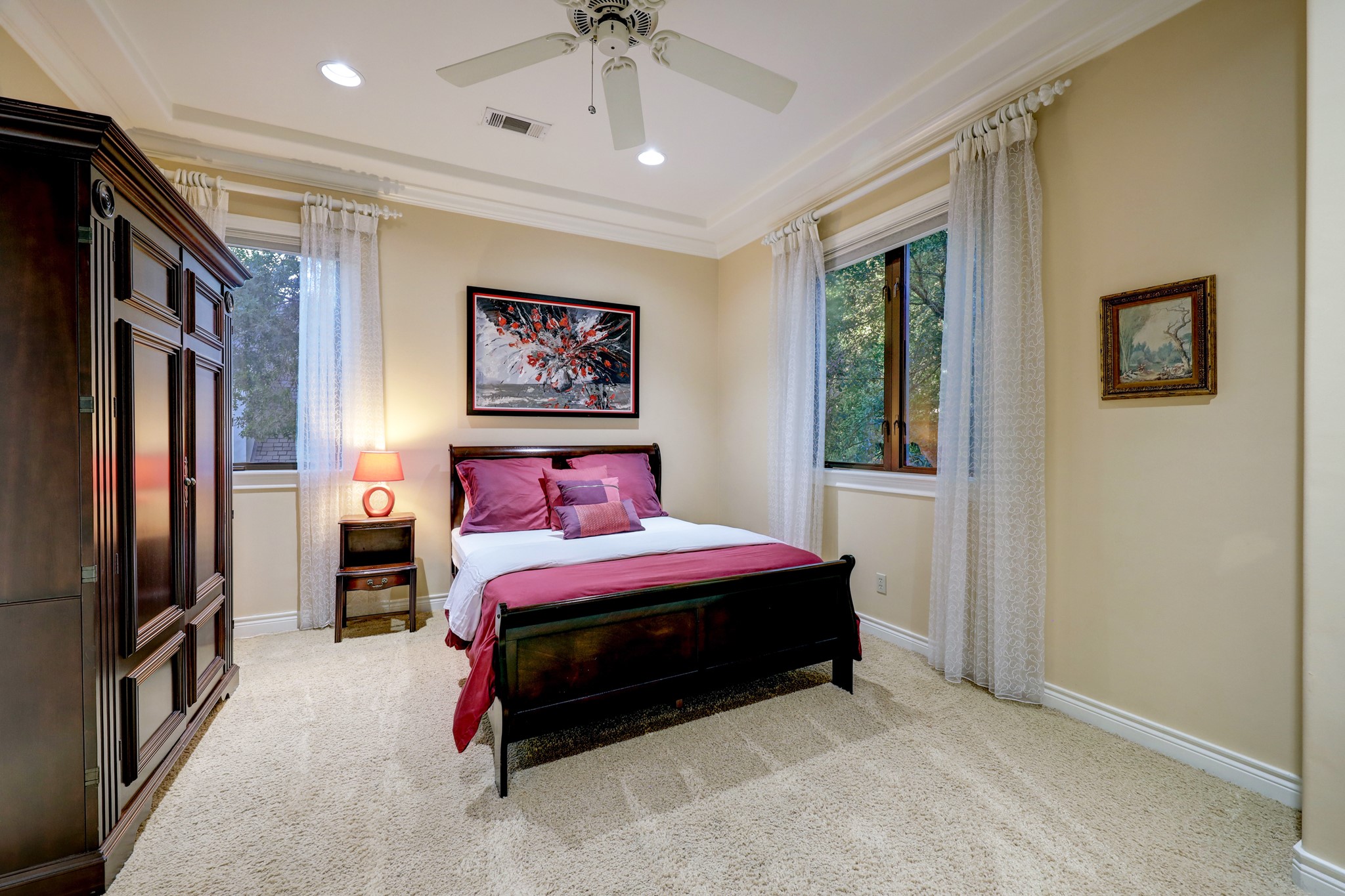 This Secondary Bedroom [18 x 13] features carpet, crown molding and baseboards, a tray ceiling a walk-in closet and en-suite bathroom.