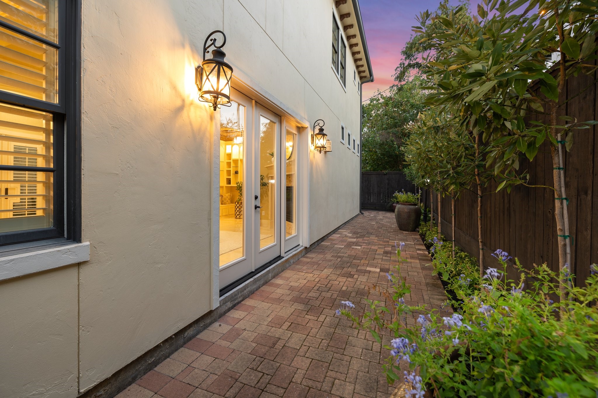 Custom outdoor lighting and glass doors to main living area.