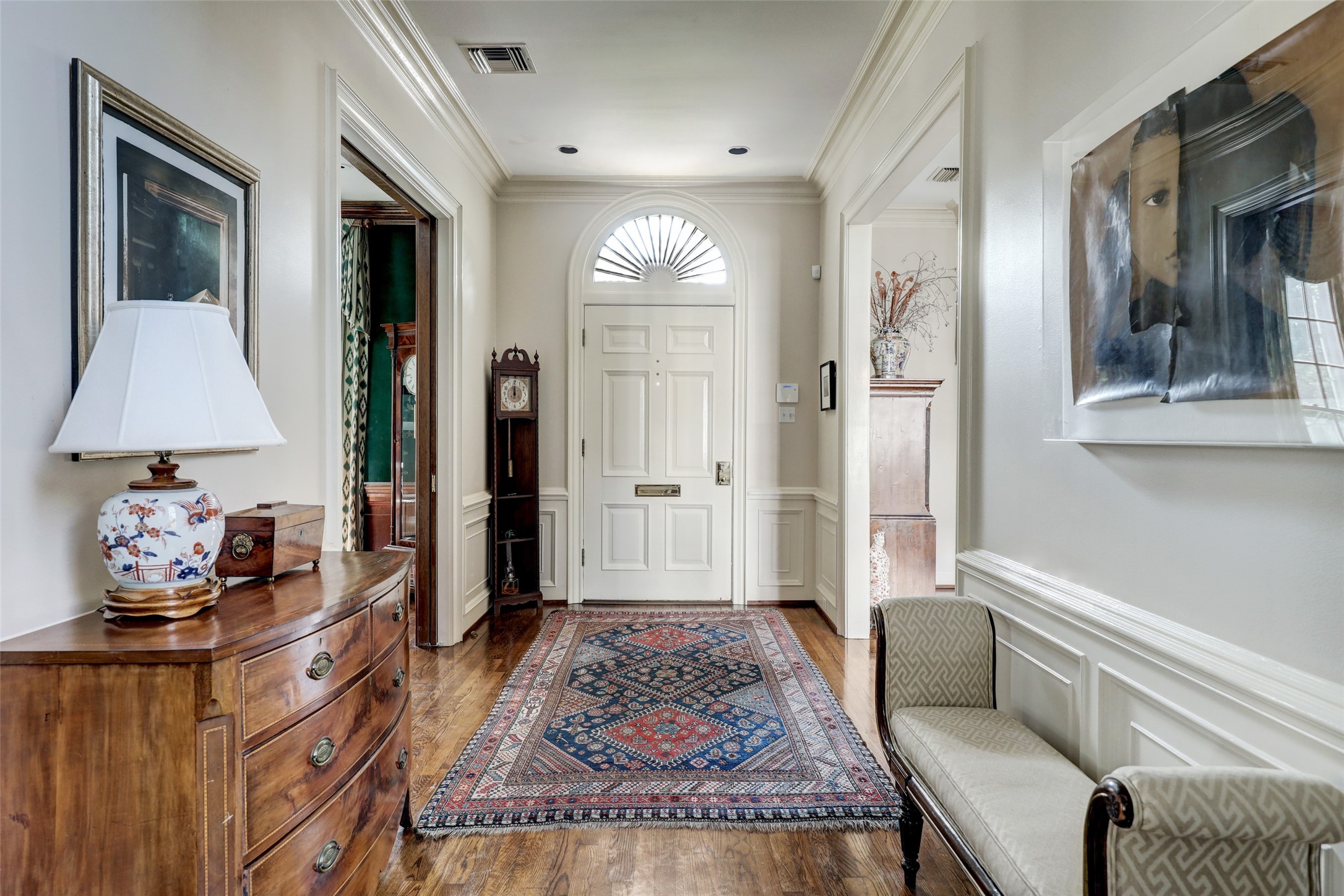 The stately entryway of this exquisite home welcomes you with gleaming hardwood floors that gently usher you to the formal living, library/home office, and formal dining room.